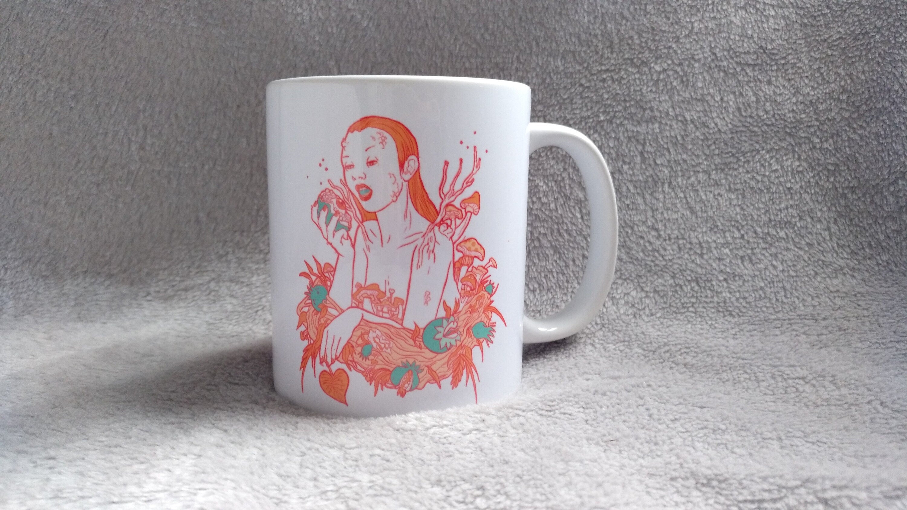 Ceramic mug featuring artwork inspired by the Greek goddess Persephone, showcasing vibrant colors and intricate designs.