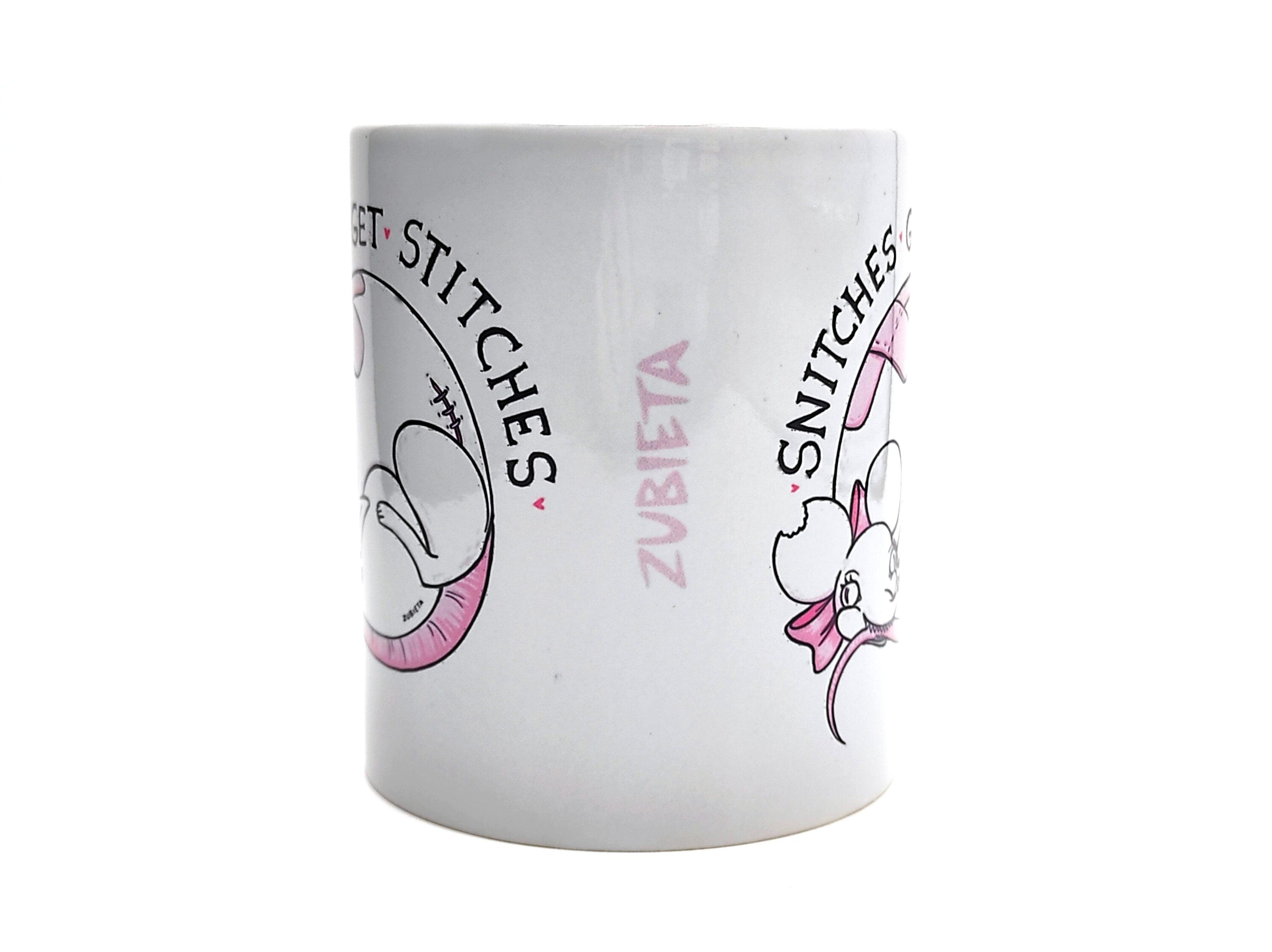 Ceramic mug featuring the phrase 'Snitches Get Stitches' with a cute evil design, perfect for coffee or tea lovers.