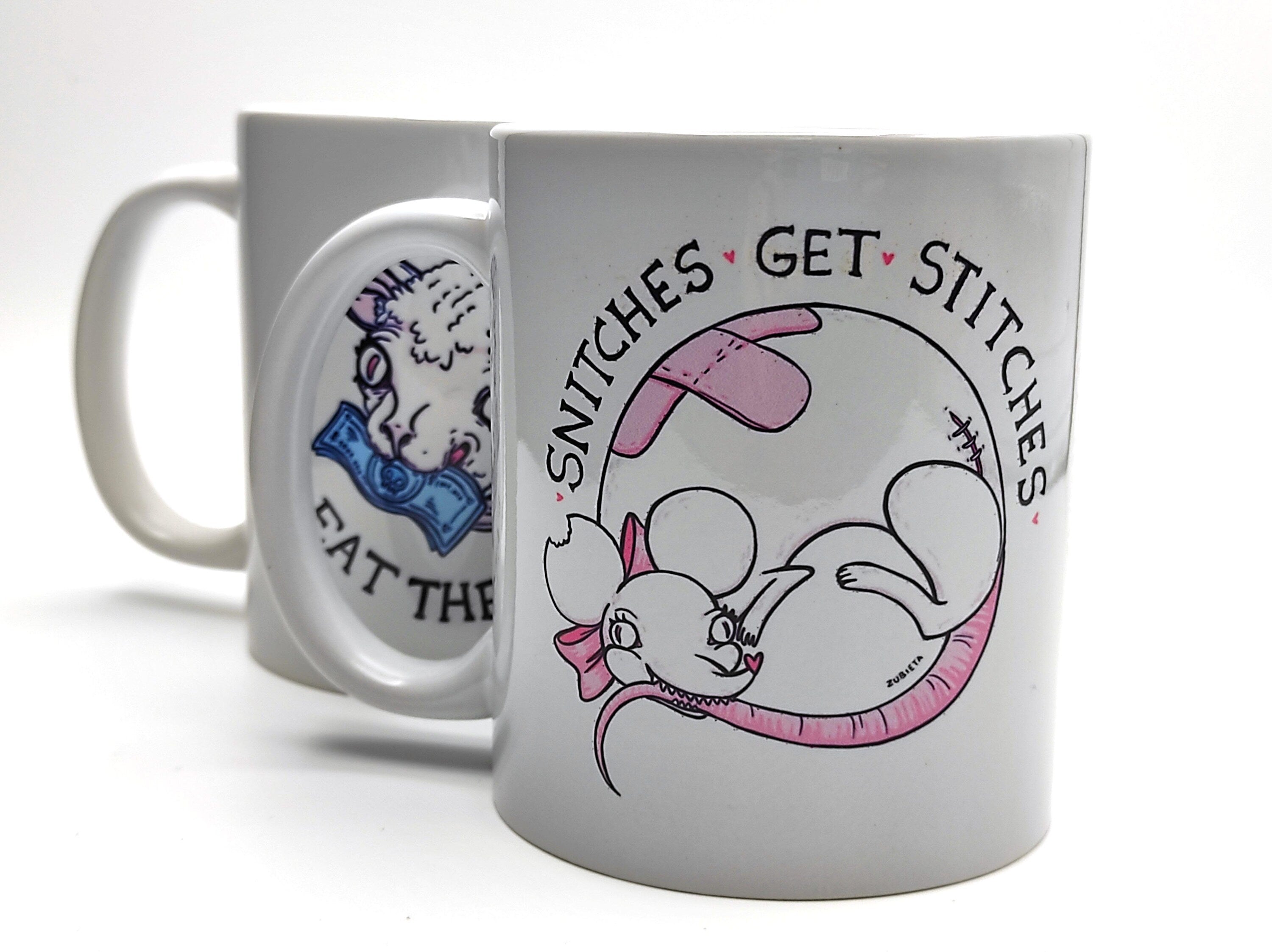 Ceramic mug featuring the phrase 'Snitches Get Stitches' with a cute evil design, perfect for coffee or tea lovers.