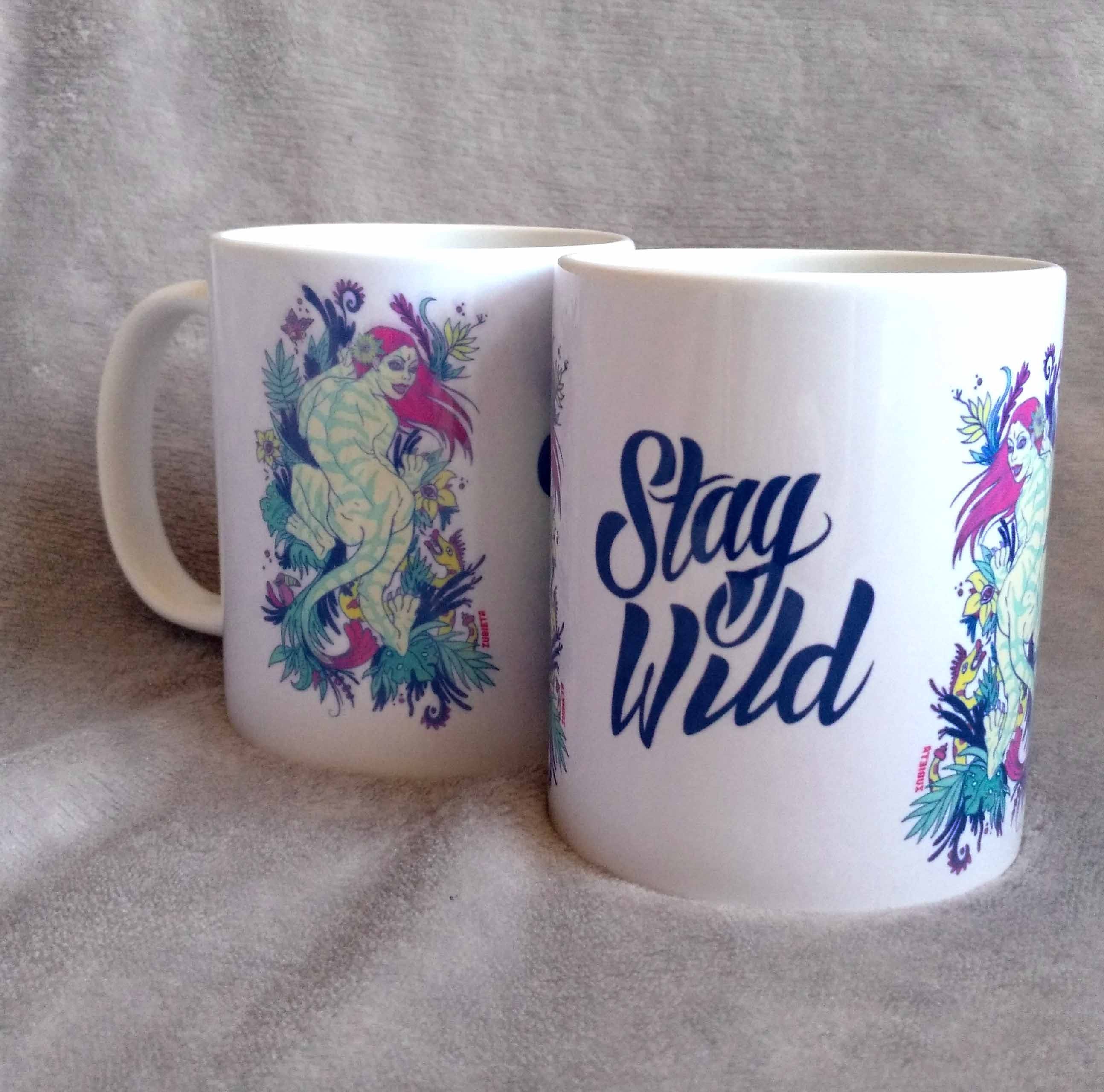 Ceramic mug featuring a vibrant tiger woman design with 'Stay Wild' lettering in the center, showcasing artistic flair.