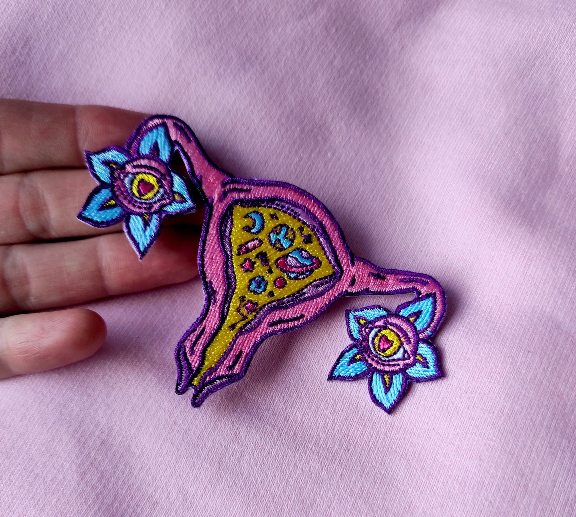 Cosmic Uterus Patch featuring a psychedelic embroidered design in six vibrant colors, measuring 12.5cm x 12.5cm.