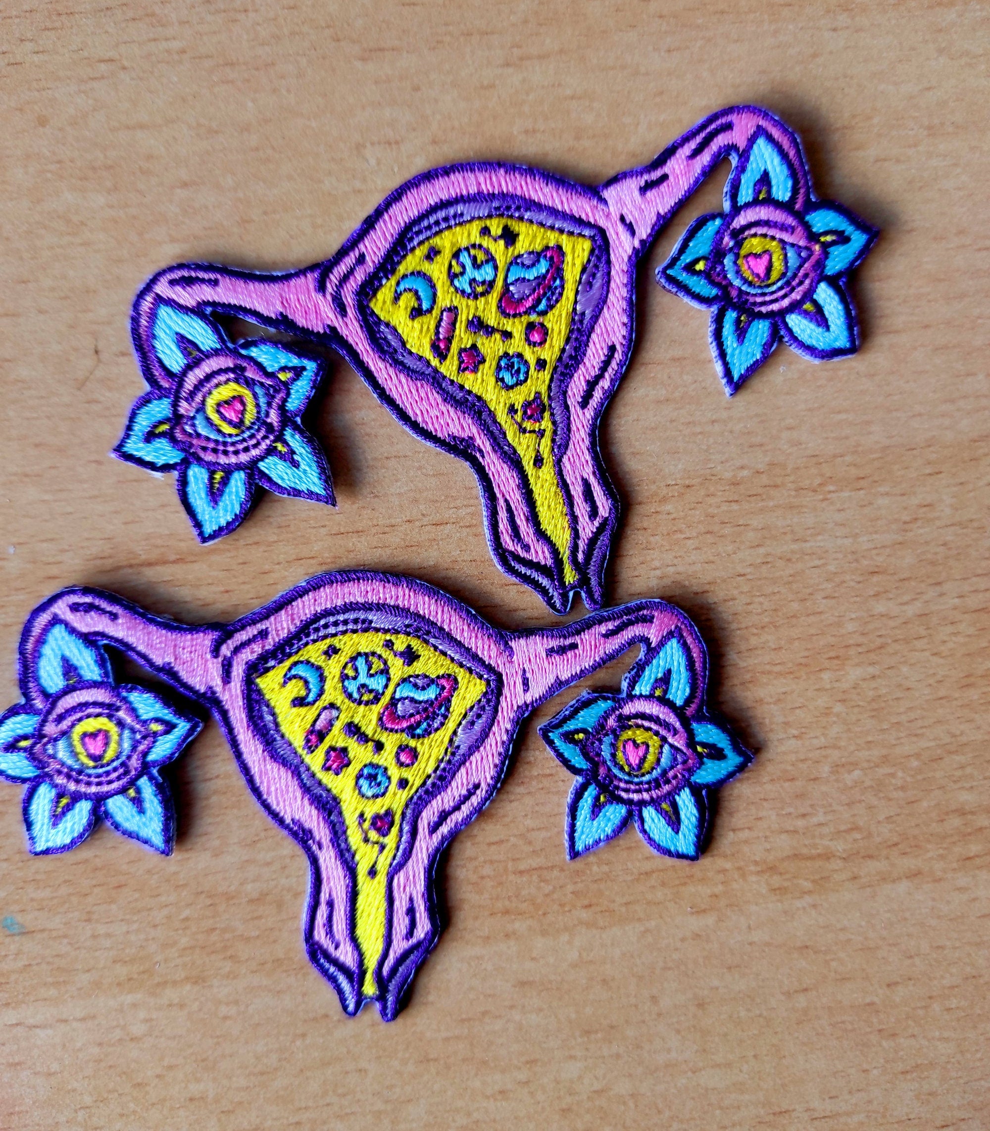 Cosmic Uterus Patch featuring a psychedelic embroidered design in six vibrant colors, measuring 12.5cm x 12.5cm.