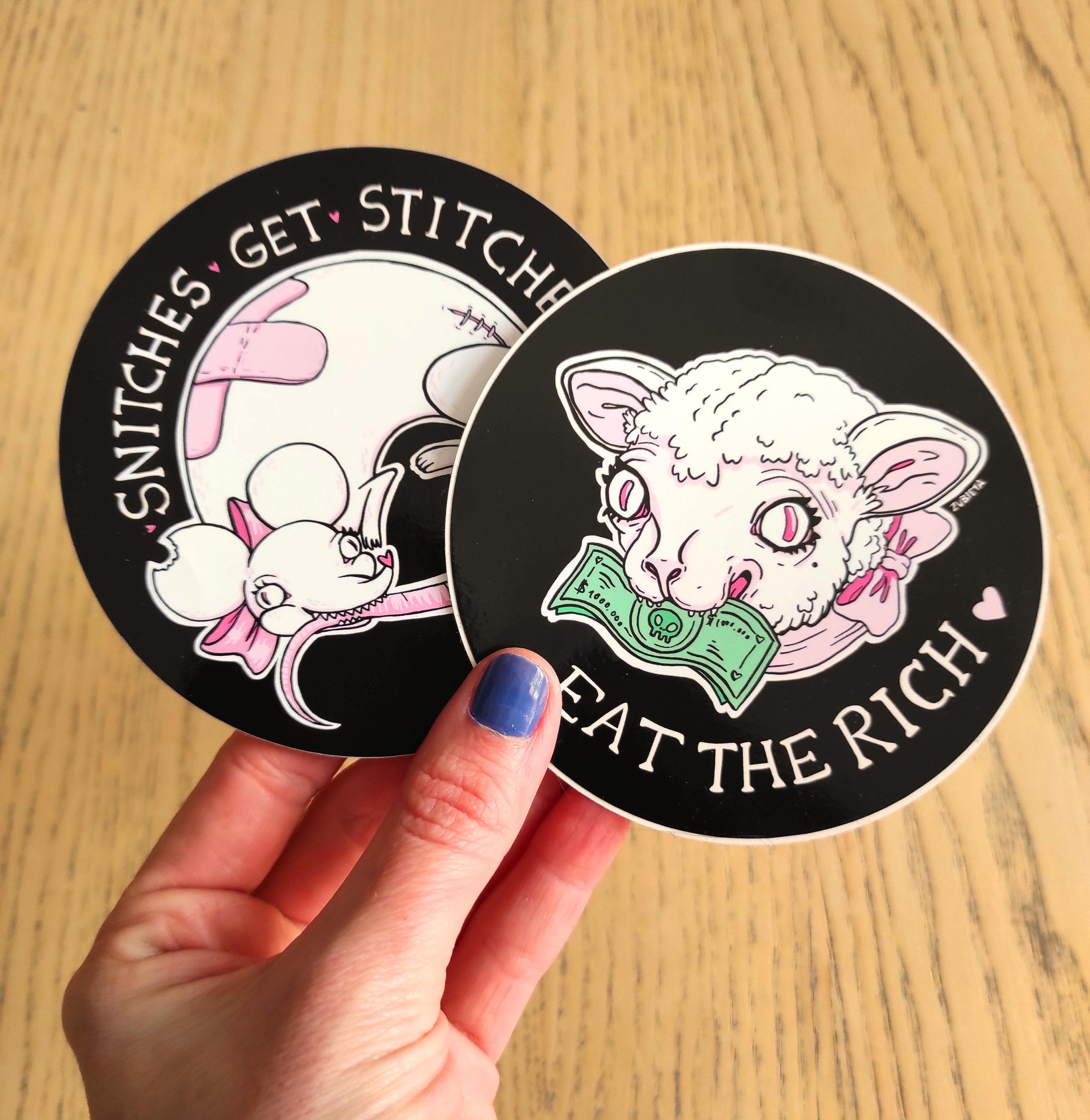 Cute Evil Sticker Pack featuring 'Eat the Rich' and 'Snitches Get Stitches' designs on high-quality vinyl.