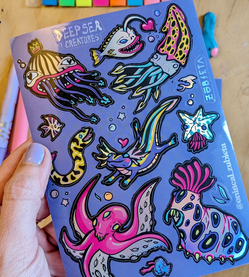 A vibrant A6 holographic sticker sheet featuring various deep sea creatures, showcasing colorful and psychedelic designs.