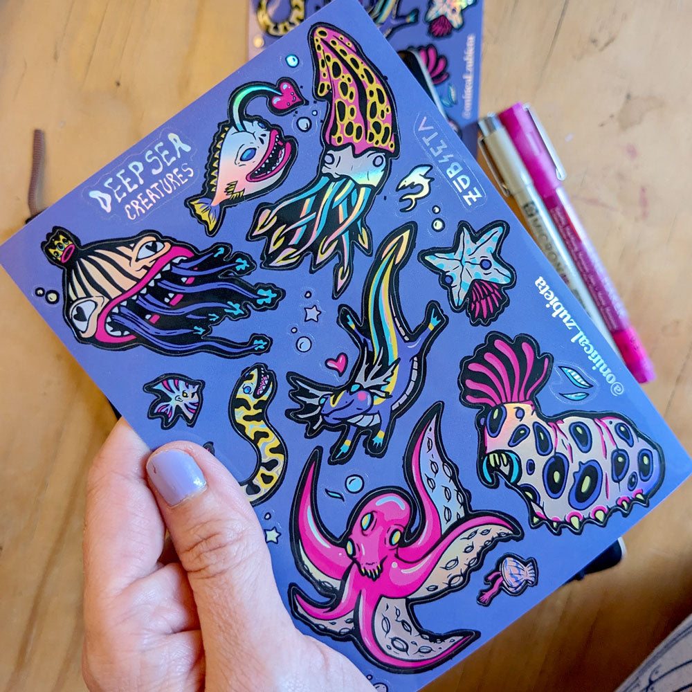 A vibrant A6 holographic sticker sheet featuring various deep sea creatures, showcasing colorful and psychedelic designs.