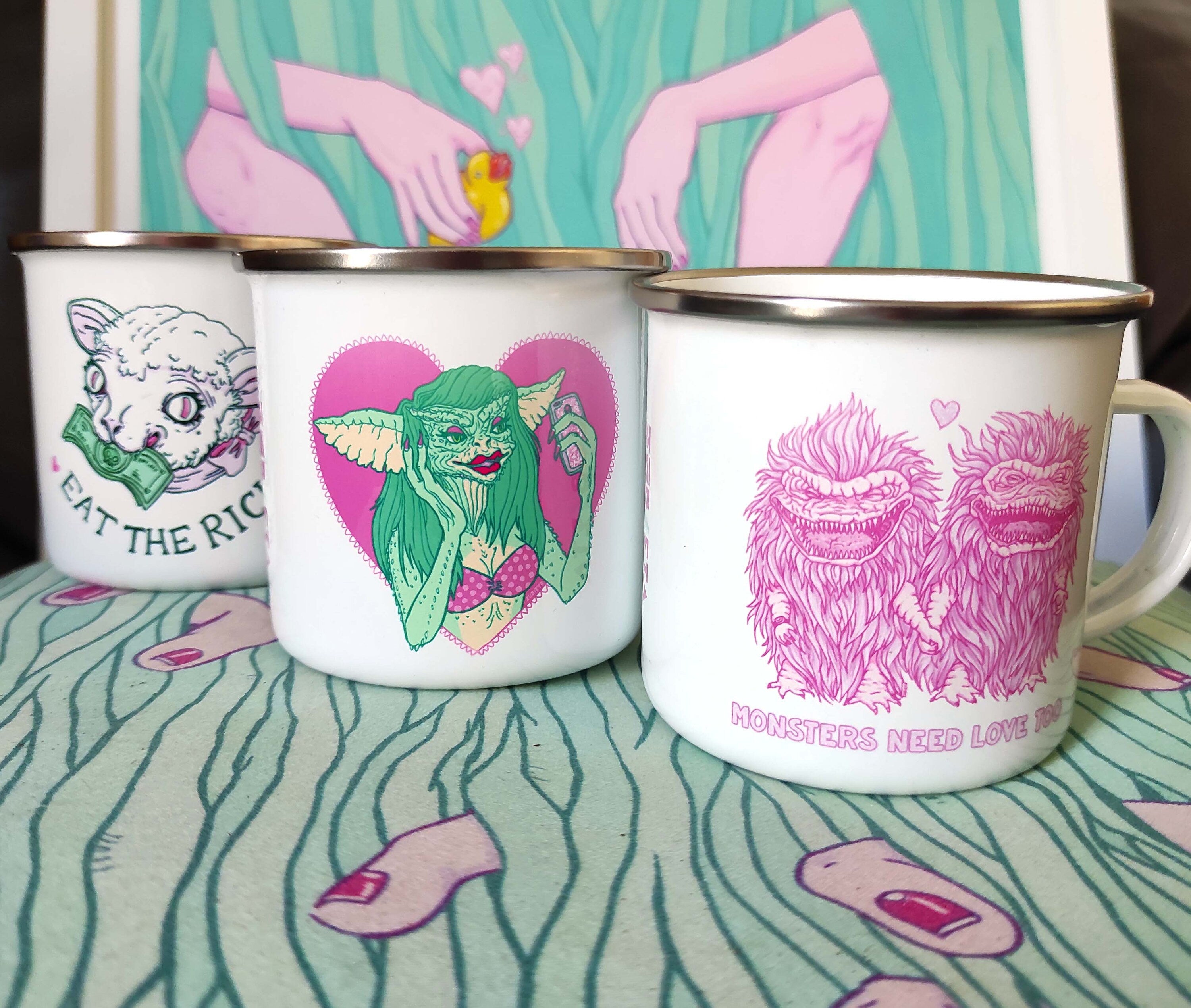 Enamel mug featuring 'Monsters Need Love Too' design inspired by The Critters, made of stainless steel, 10oz capacity.