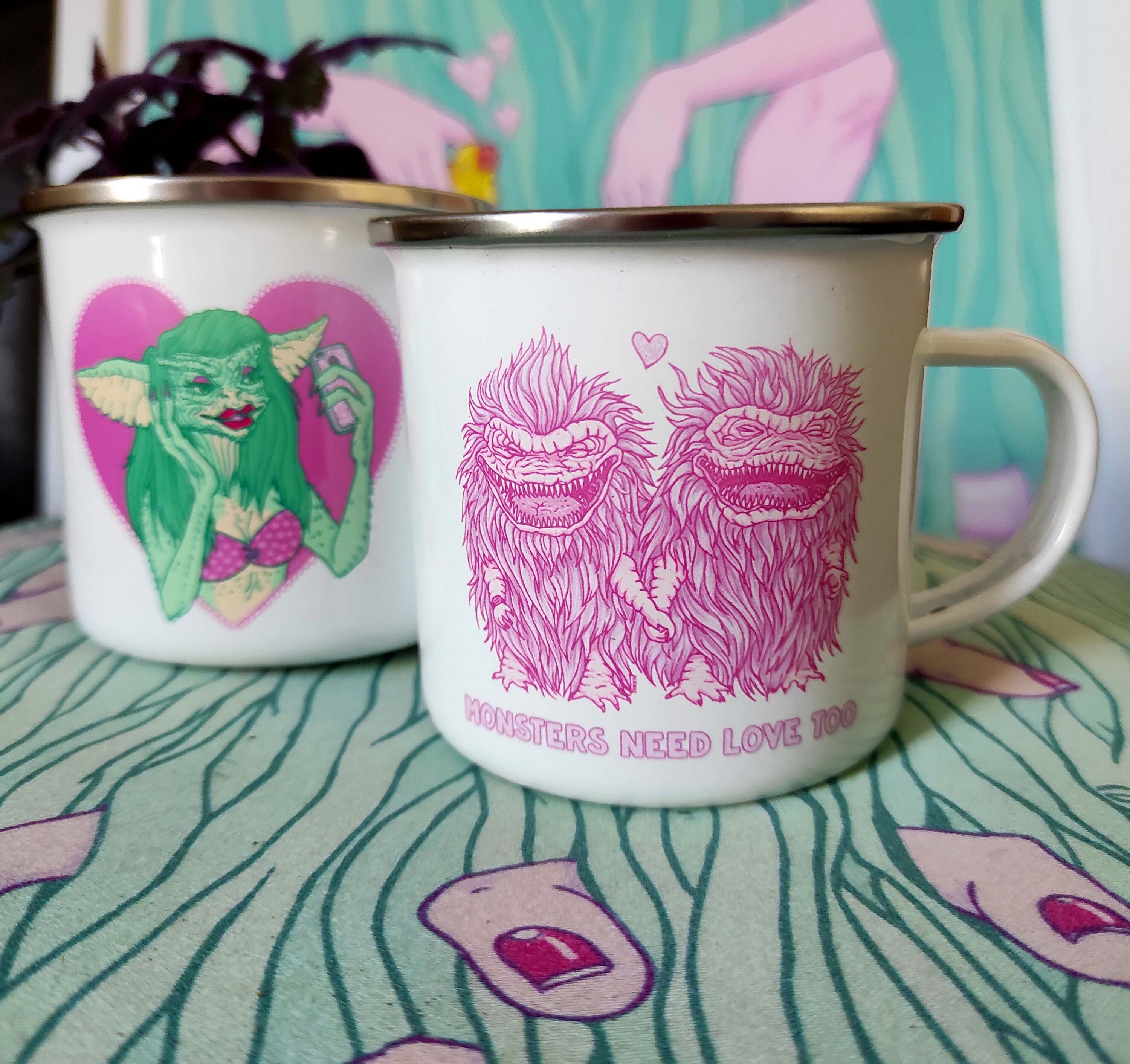 Enamel mug featuring 'Monsters Need Love Too' design inspired by The Critters, made of stainless steel, 10oz capacity.