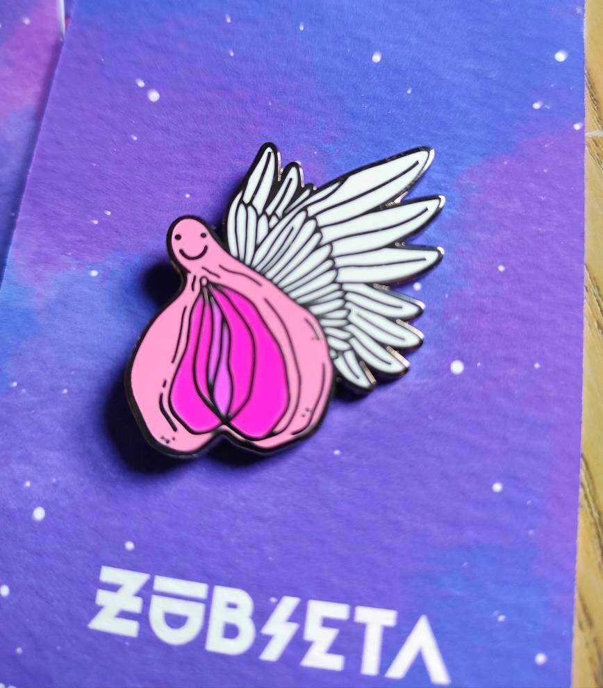 A colorful enamel pin featuring a whimsical design of flying vaginas in space, symbolizing body positivity and empowerment.