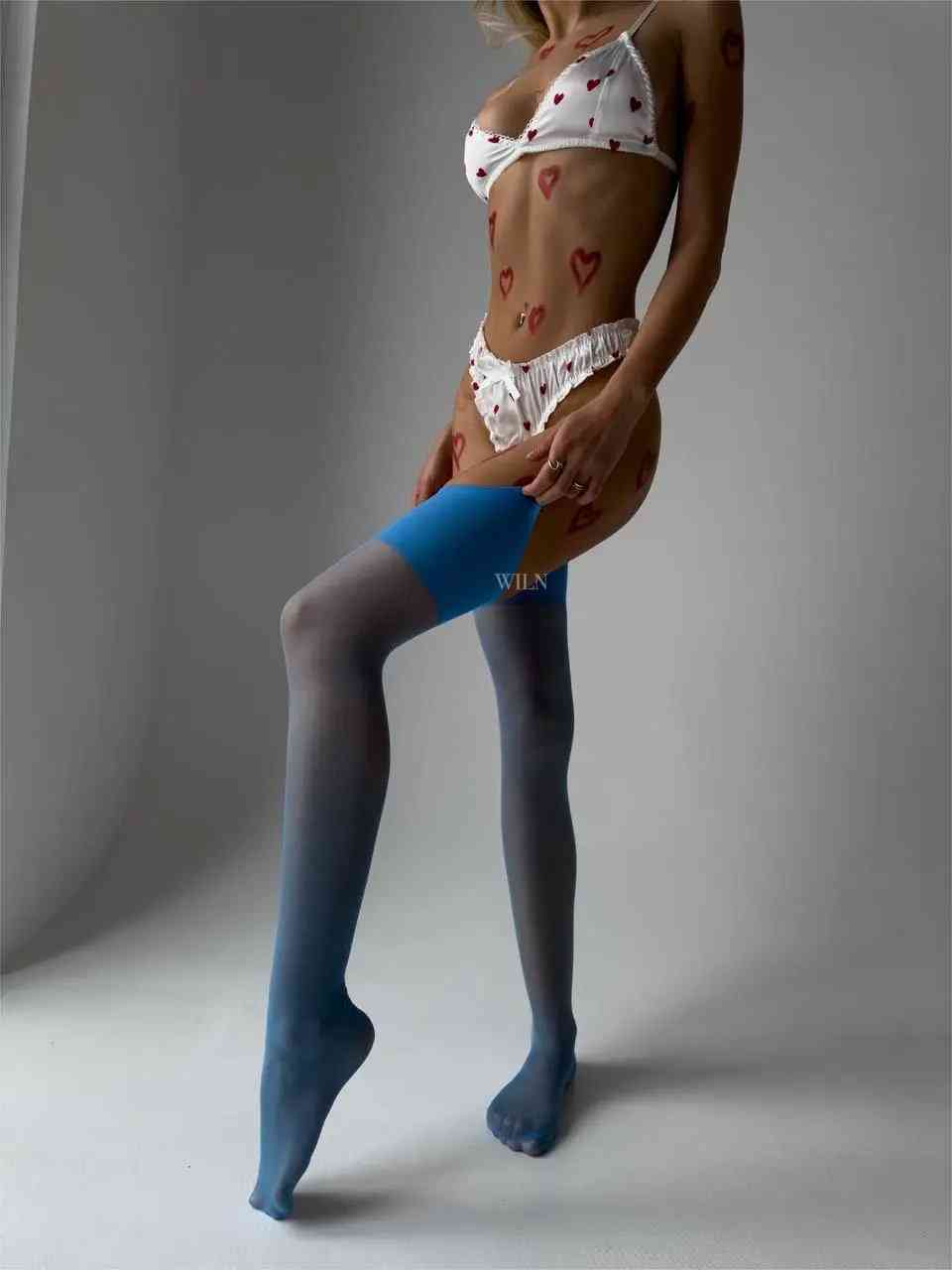 A pair of elegant blue GLAM stockings with a glossy finish, showcasing their luxurious design and vibrant color.