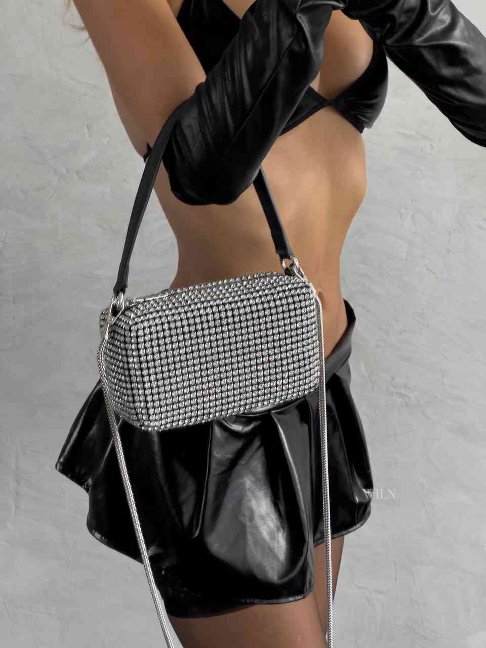 EXCESS sparkle bag featuring black exterior and silver rhinestones, designed as a medium-size bucket handbag with a detachable strap.