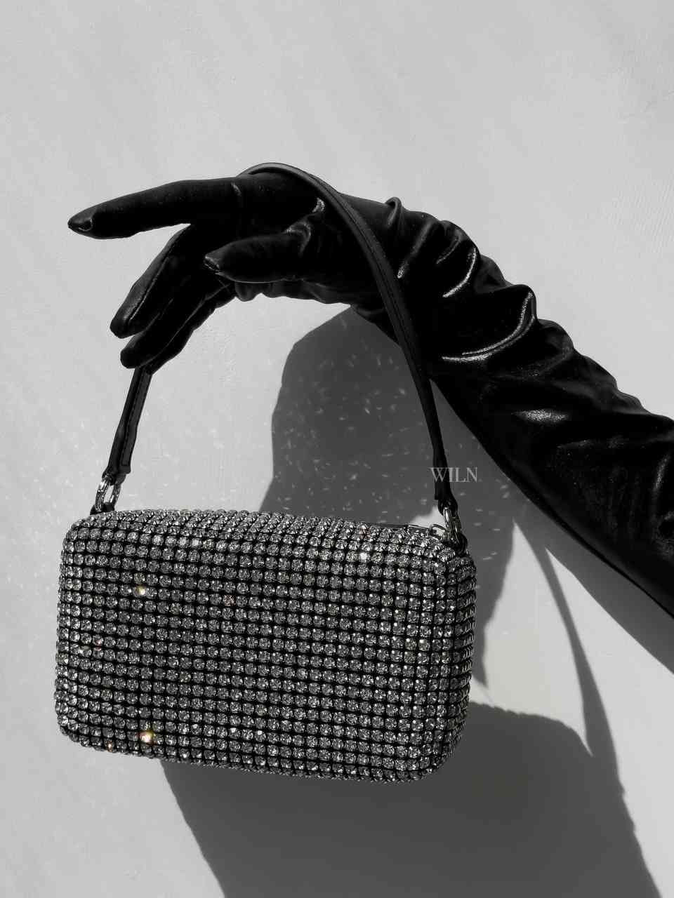 EXCESS sparkle bag featuring black exterior and silver rhinestones, designed as a medium-size bucket handbag with a detachable strap.