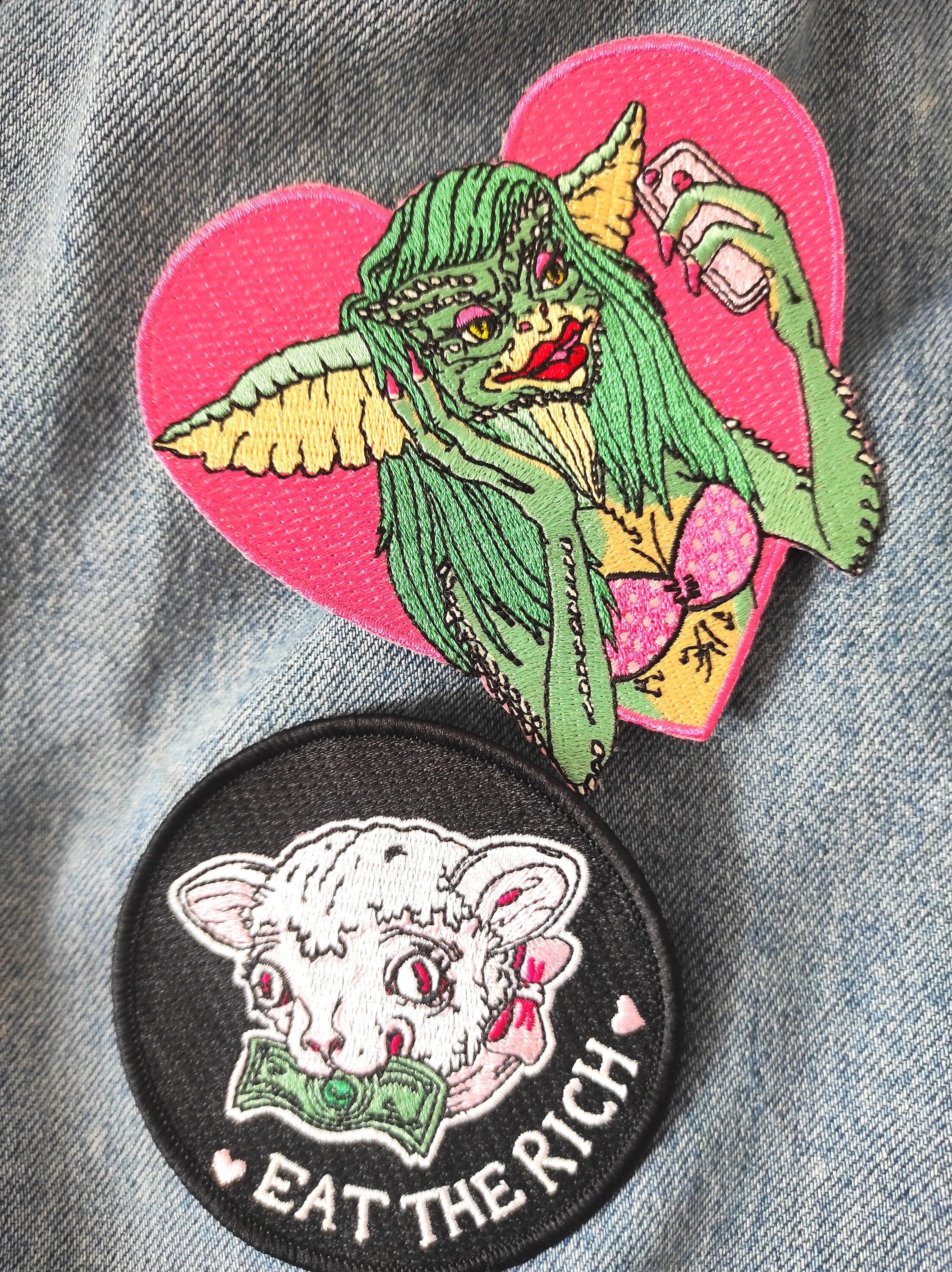 Greta The Gremlin Embroidered Patch featuring vibrant colors and playful design, measuring 12.5cm x 12.5cm.