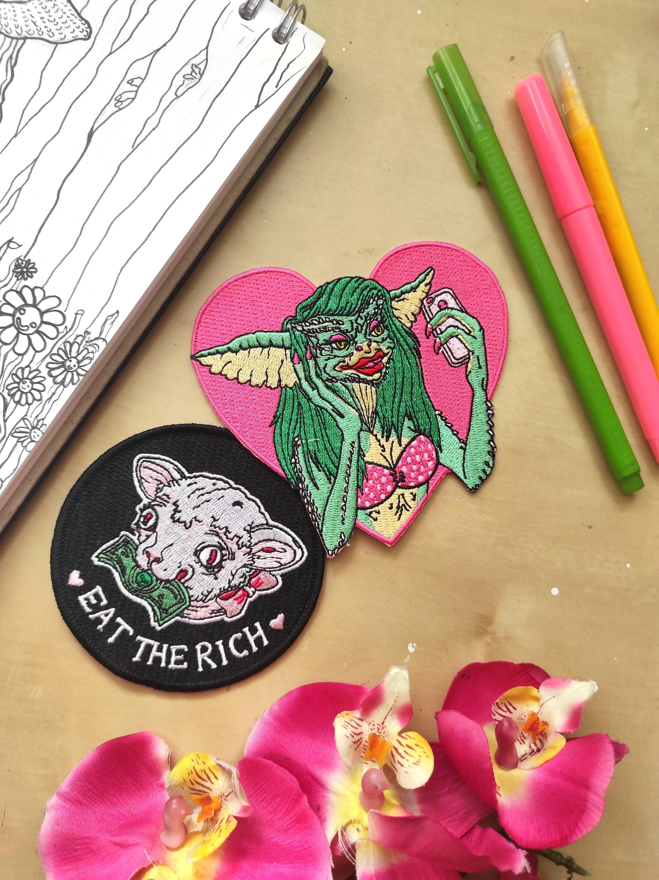 Greta The Gremlin Embroidered Patch featuring vibrant colors and playful design, measuring 12.5cm x 12.5cm.