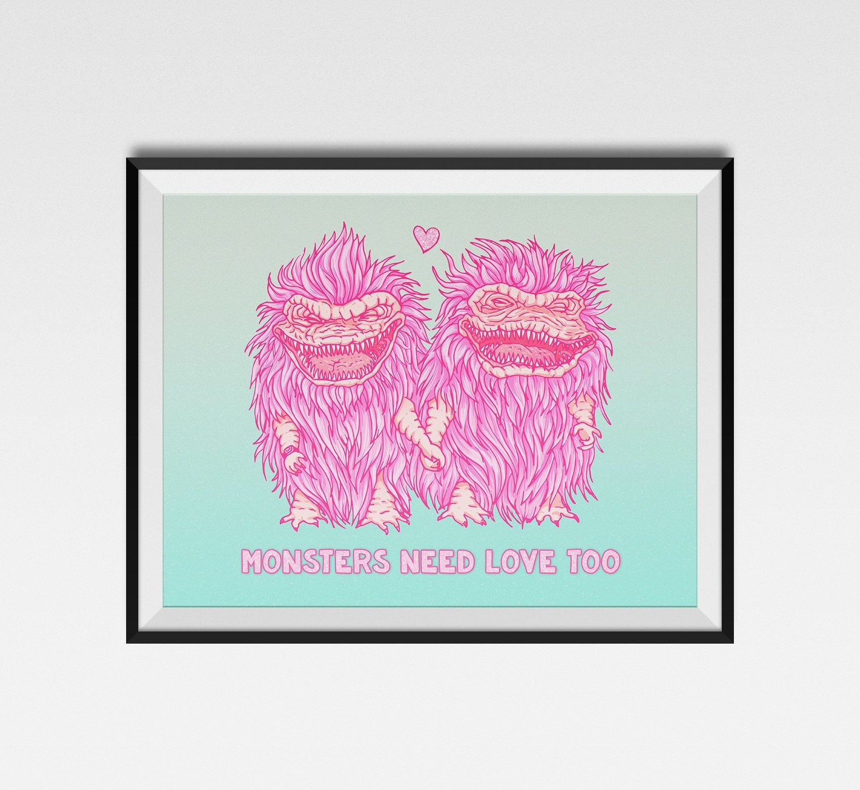 A vibrant gicleé print titled 'Monsters Need Love Too', featuring whimsical monsters inspired by The Critters movie, with a handwritten signature.