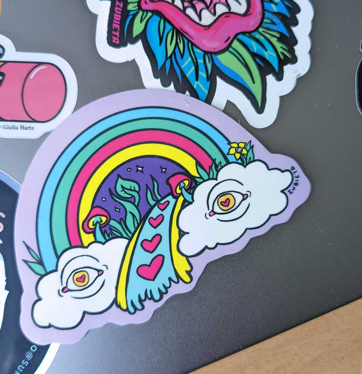 A colorful psychedelic rainbow vinyl sticker, showcasing vibrant hues and intricate designs, perfect for personalizing various items.