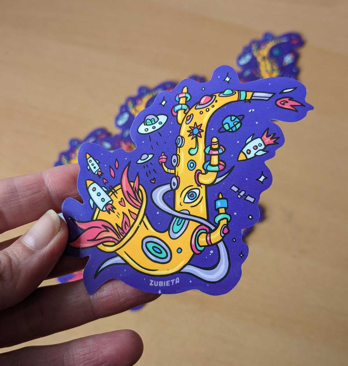 Colorful Spacey Sax sticker featuring a saxophone design, perfect for decorating personal items.