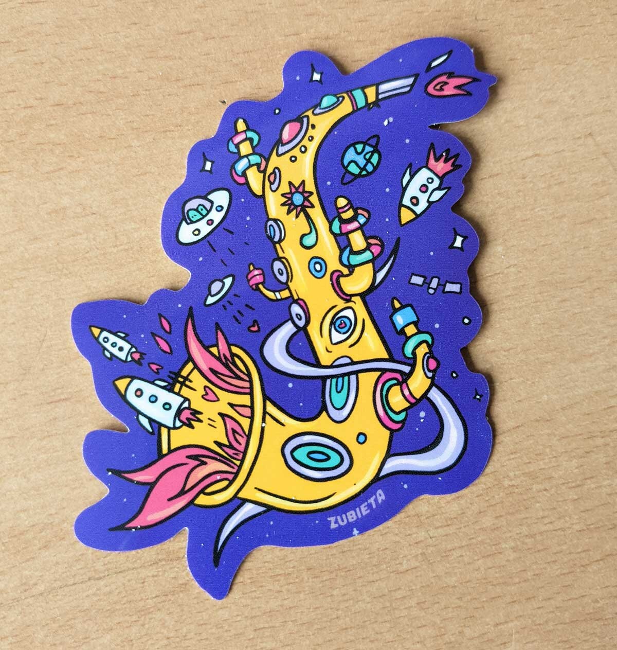 Colorful Spacey Sax sticker featuring a saxophone design, perfect for decorating personal items.