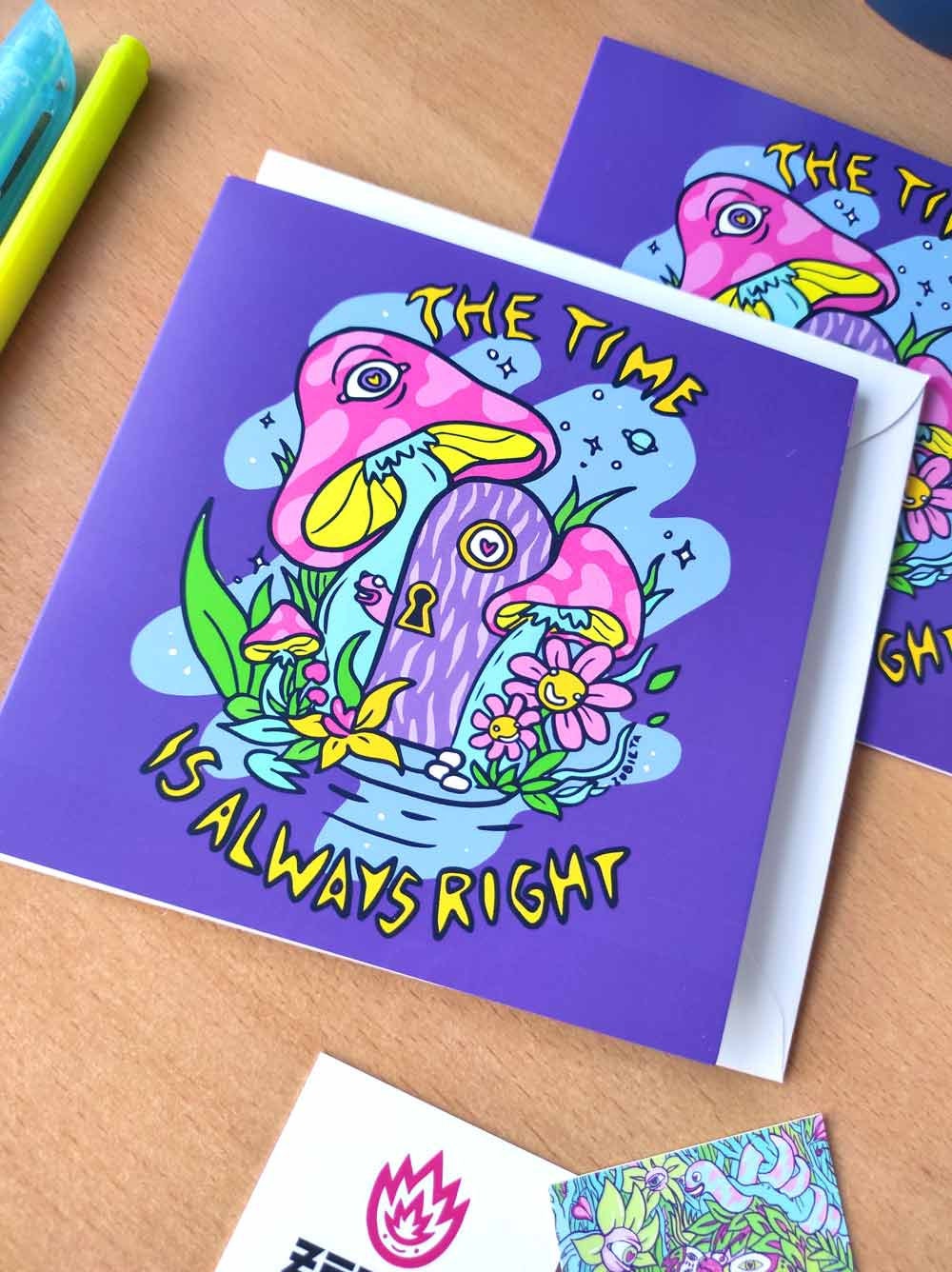 A vibrant psychedelic greeting card titled 'The Time Is Always Right', featuring colorful digital art, a square envelope, and a sticker.