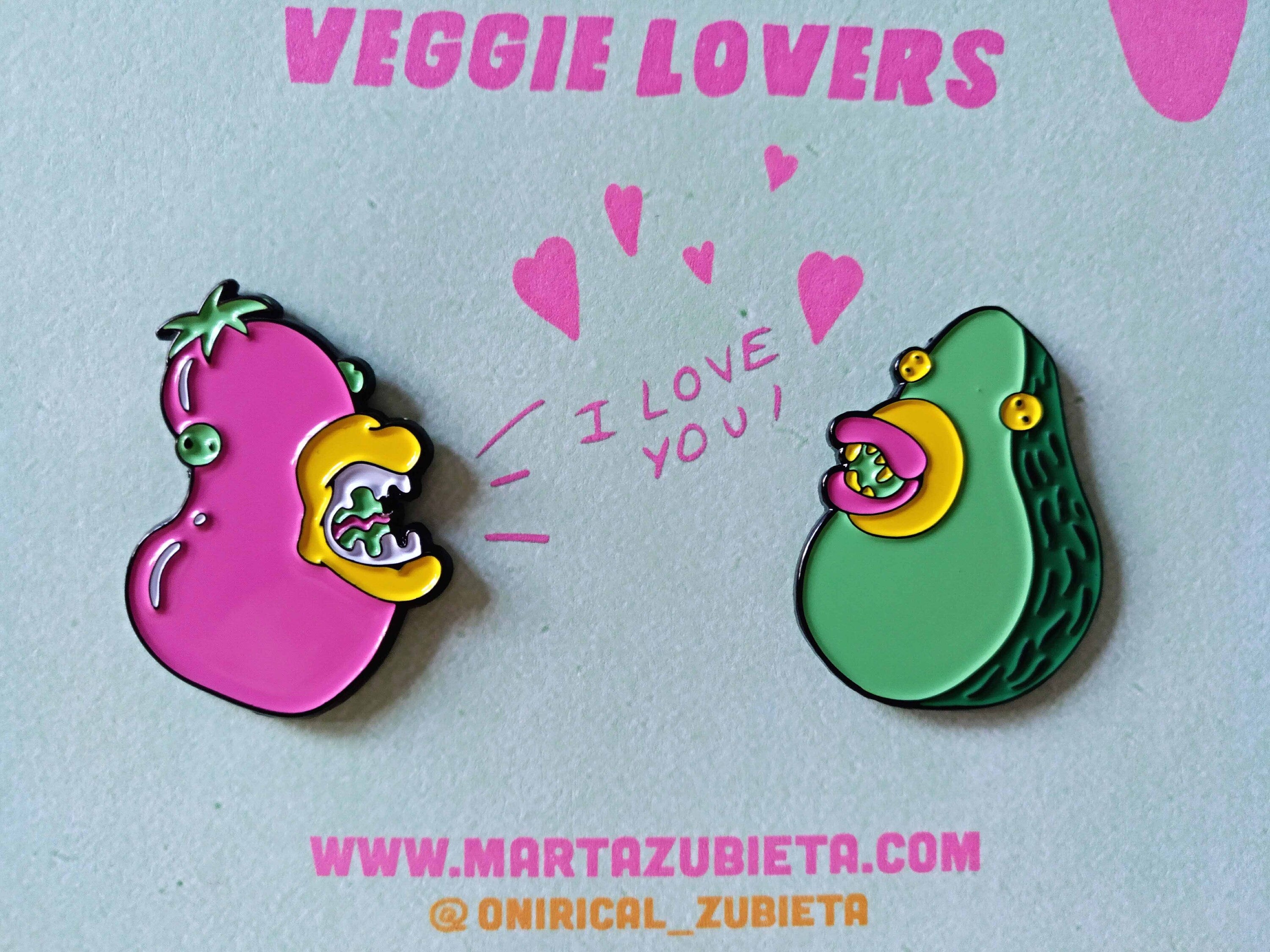 A colorful enamel pin pack featuring avocado and aubergine designs, made from black metal with soft enamel colors.