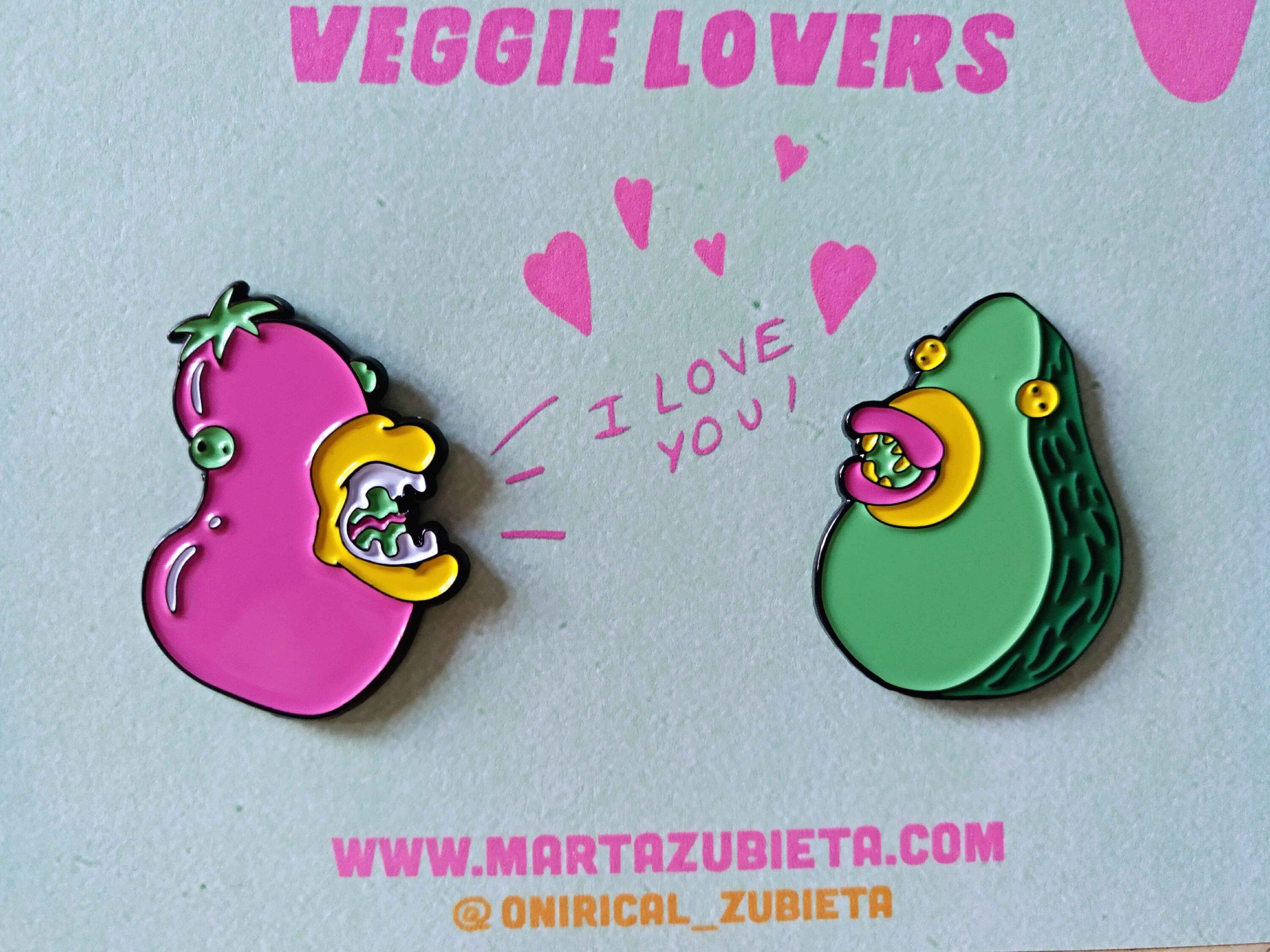 A colorful enamel pin pack featuring avocado and aubergine designs, made from black metal with soft enamel colors.