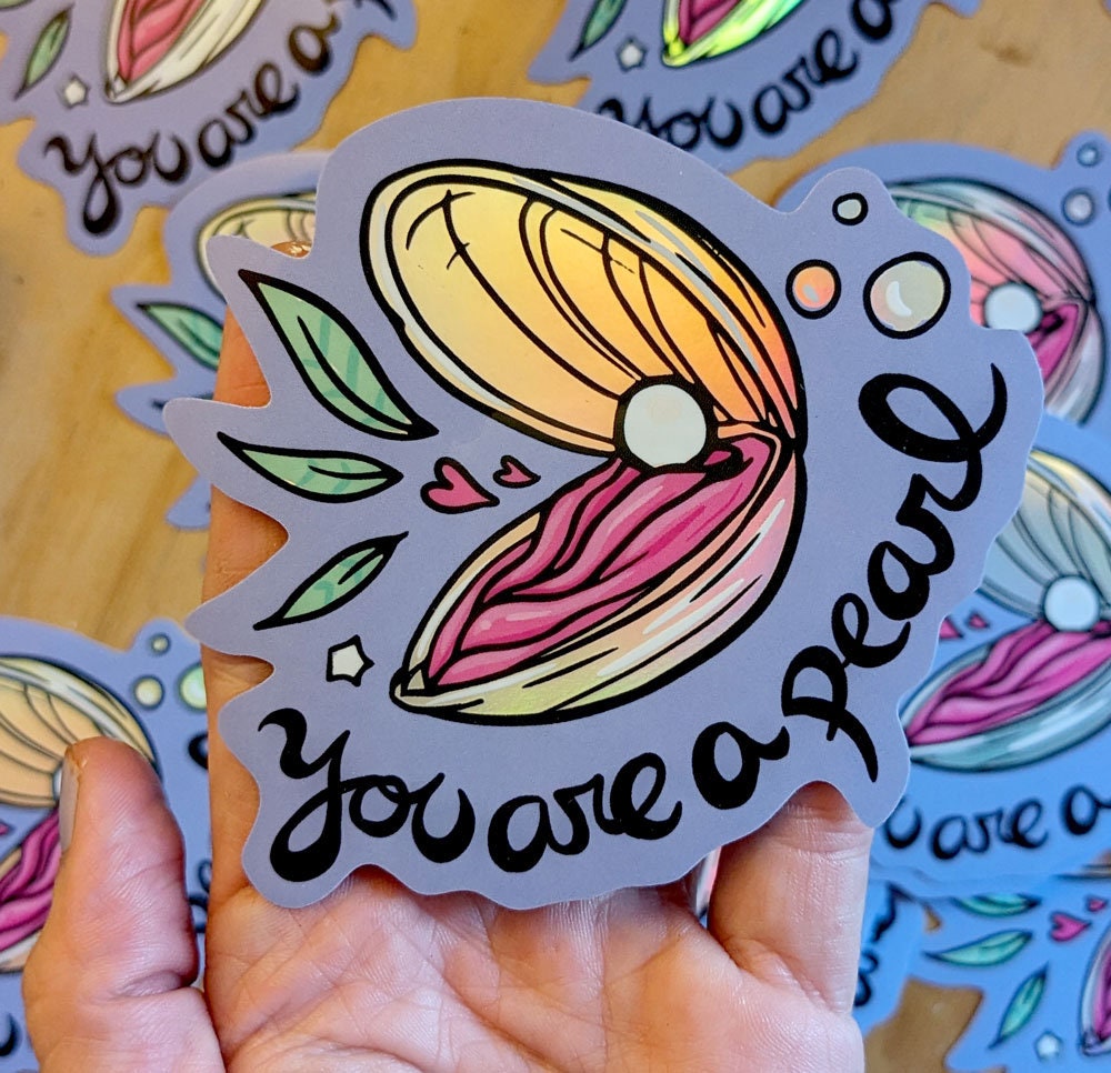 You Are a Pearl Holographic Vinyl Sticker featuring an oyster shell design with a shimmering holographic finish.