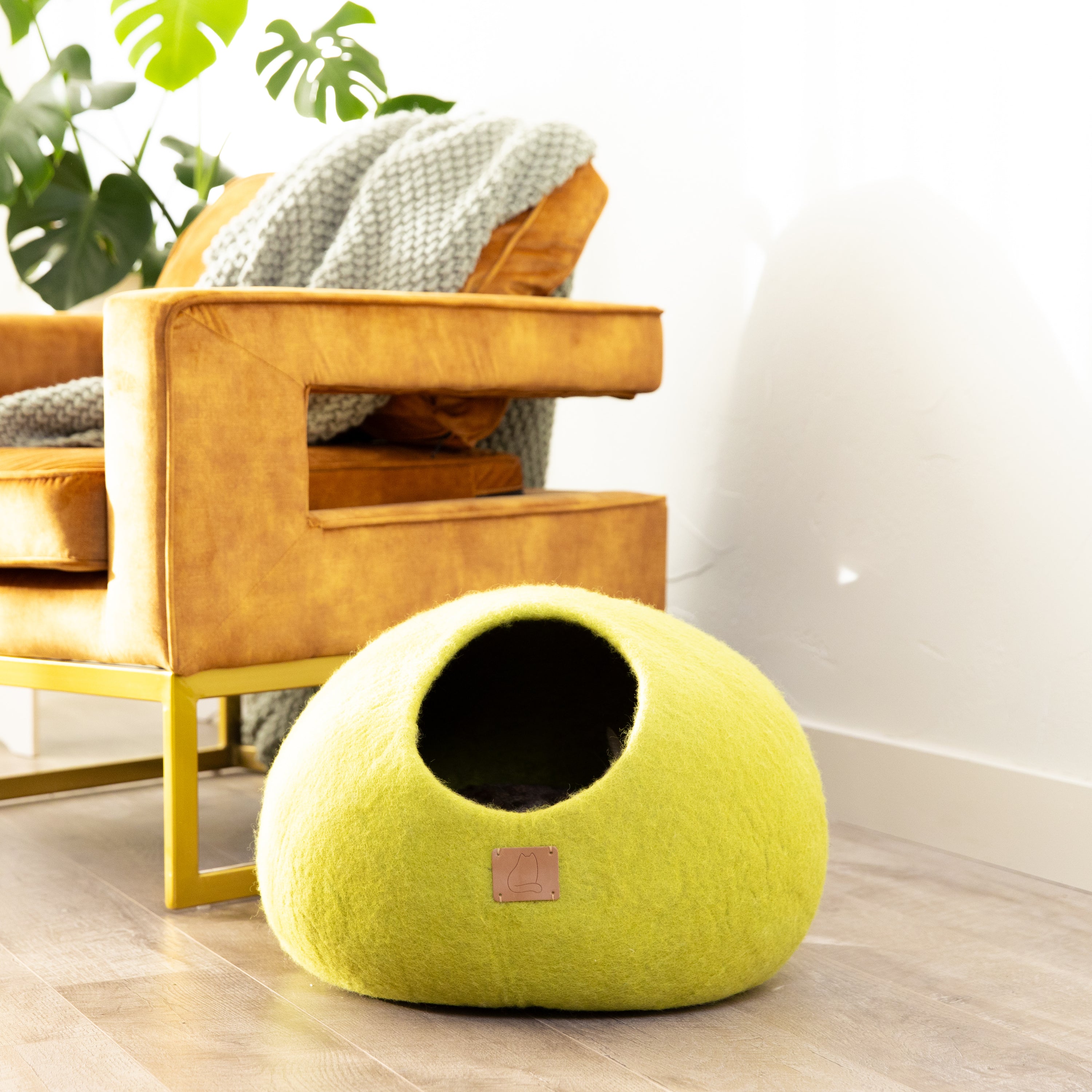 Citrus Green round style cat cave bed made from luxurious felted wool, featuring a peekaboo design for cats to relax and play.