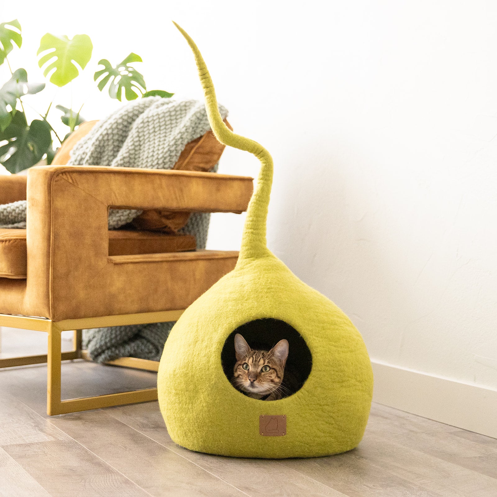 Citrus Green Tail Style Cave, a modern cat cave made of felted wool, featuring a peekaboo entrance and a vibrant color, perfect for stylish pet owners.