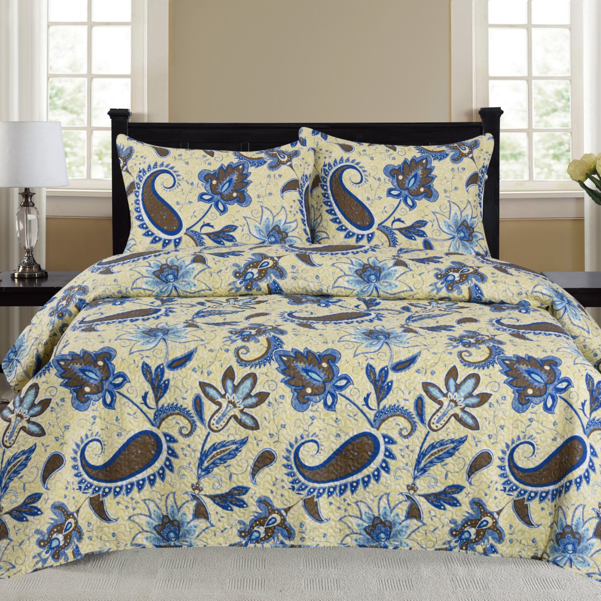 Cynthia 3 Piece Quilt Set in Blue featuring a quilt and two matching pillow shams, elegantly displayed on a bed.