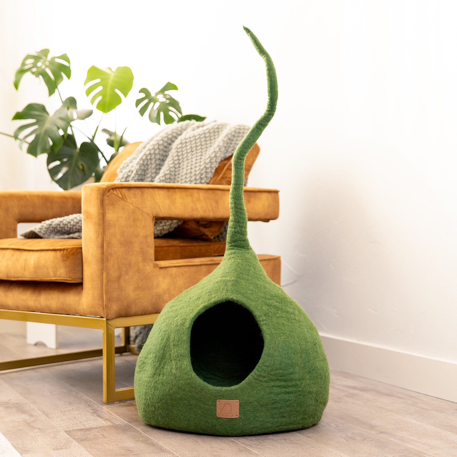 Forest Green Tail Style Cave, a cozy and stylish cat bed made from felted wool, featuring a peekaboo entrance and a modern design.