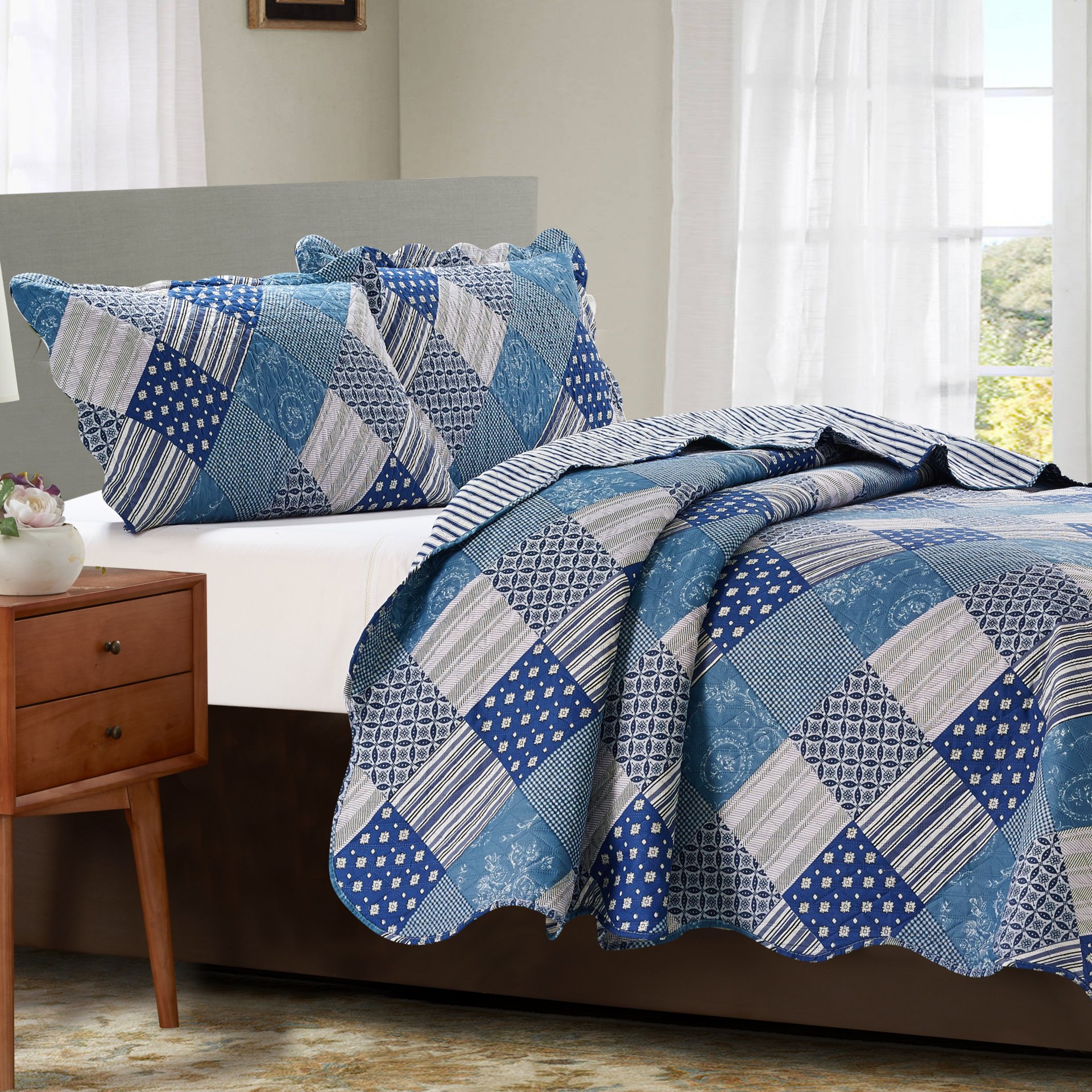 Jennifer 3 Piece Quilt Set in Blue, featuring a quilt and two matching pillow shams, elegantly styled for a cozy bedroom decor.