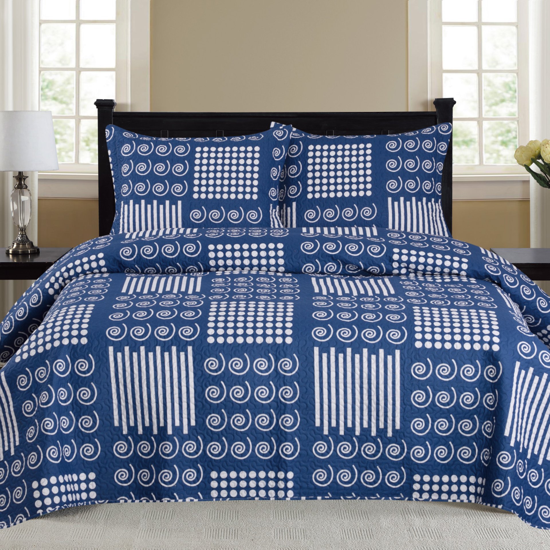 Nikki 3 Piece Quilt Set in Navy featuring a quilt and two matching pillow shams, elegantly styled for a cozy bedroom look.