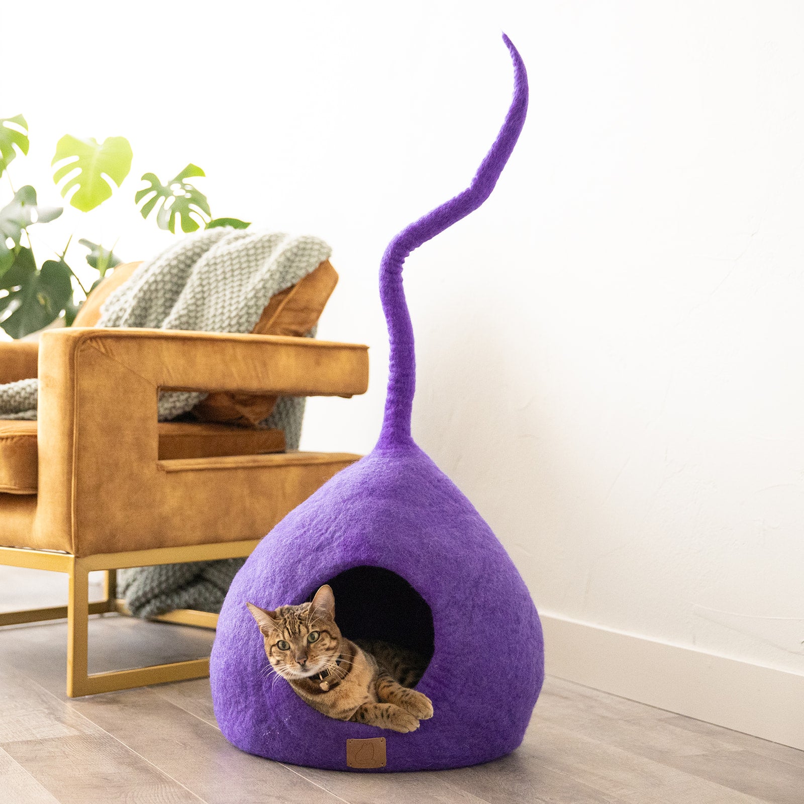 Plum Purple Tail Style Cave, a chic and cozy cat bed made from felted wool, featuring a peekaboo entrance and modern design.