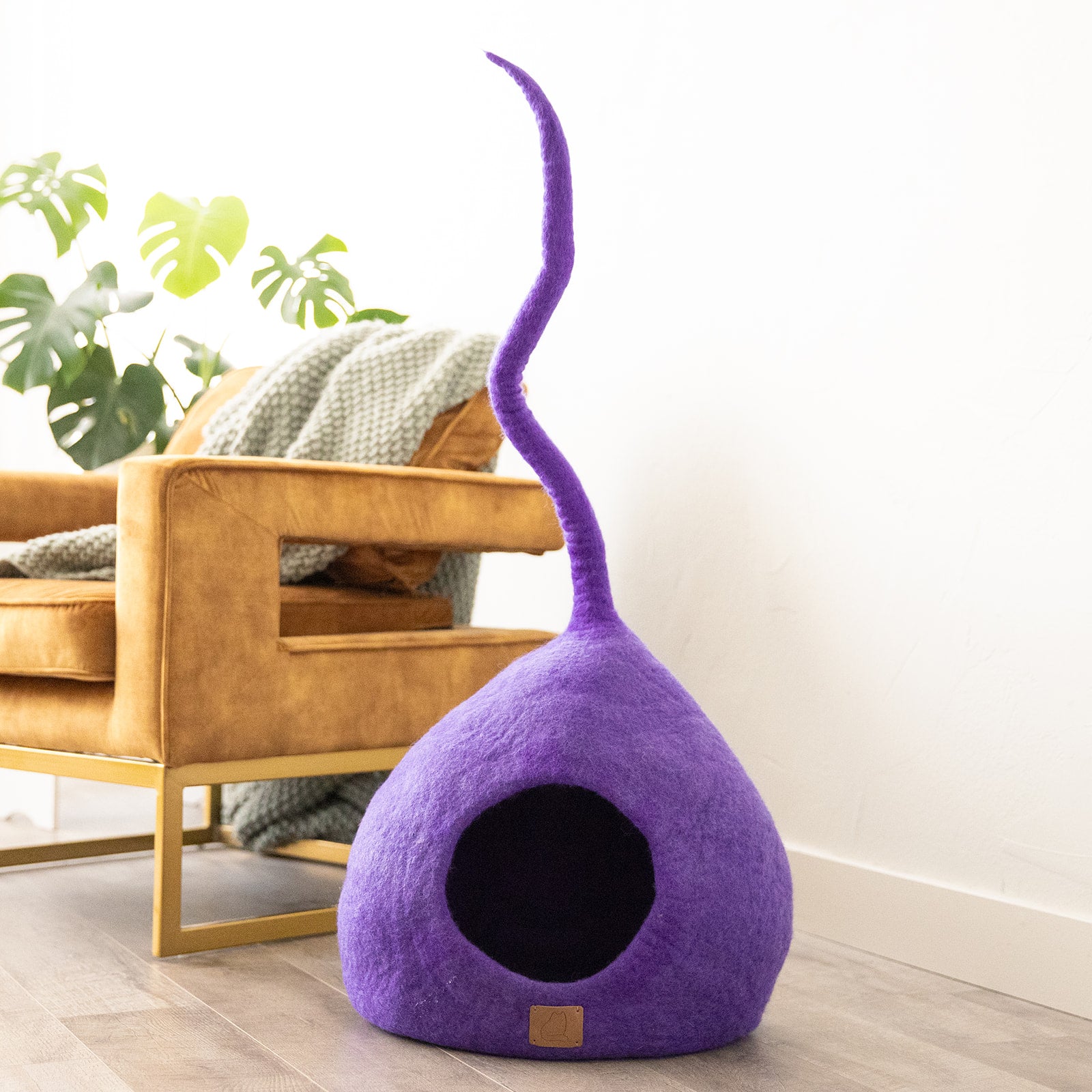 Plum Purple Tail Style Cave, a chic and cozy cat bed made from felted wool, featuring a peekaboo entrance and modern design.