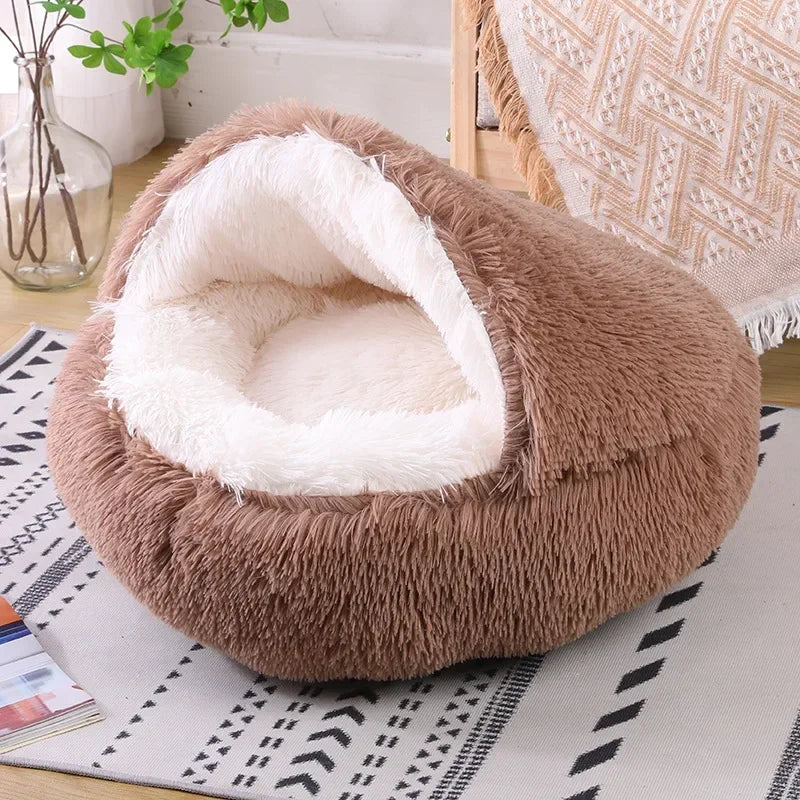 A cozy Plush Round Cat Bed in gray, brown, and pink colors, designed for comfort with a soft plush material, perfect for cats to relax and sleep.