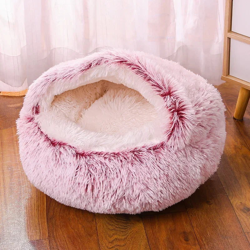 A cozy Plush Round Cat Bed in gray, brown, and pink colors, designed for comfort with a soft plush material, perfect for cats to relax and sleep.