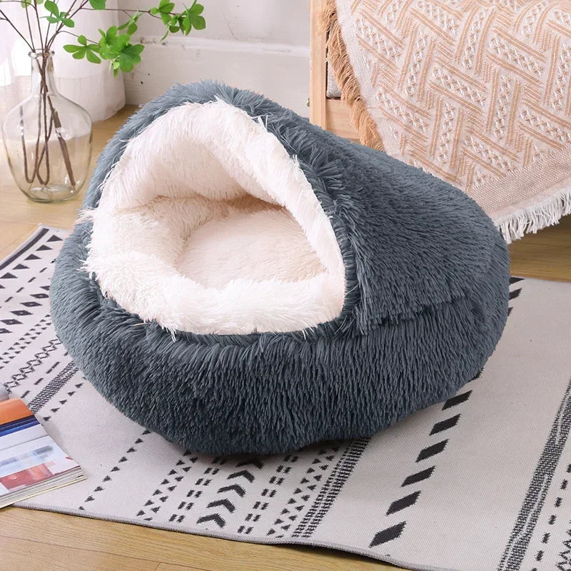 A cozy Plush Round Cat Bed in gray, brown, and pink colors, designed for comfort with a soft plush material, perfect for cats to relax and sleep.