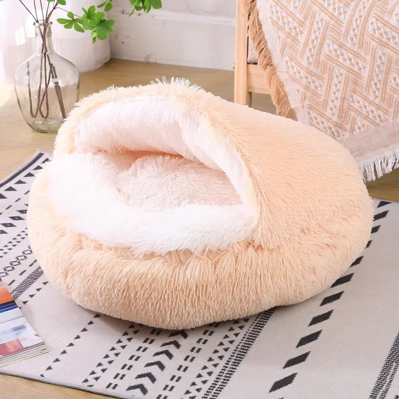 A cozy Plush Round Cat Bed in gray, brown, and pink colors, designed for comfort with a soft plush material, perfect for cats to relax and sleep.