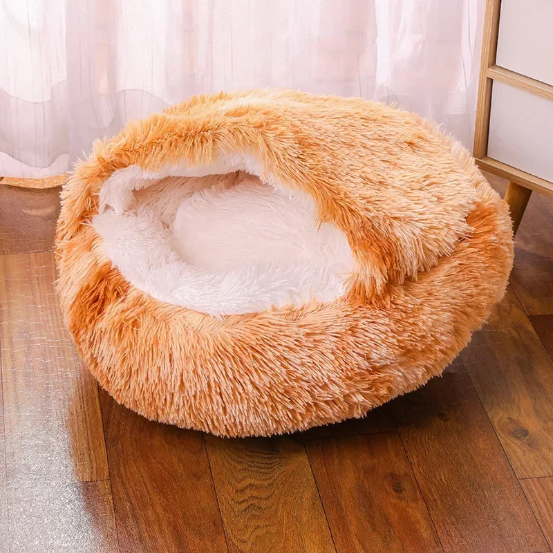 A cozy Plush Round Cat Bed in gray, brown, and pink colors, designed for comfort with a soft plush material, perfect for cats to relax and sleep.