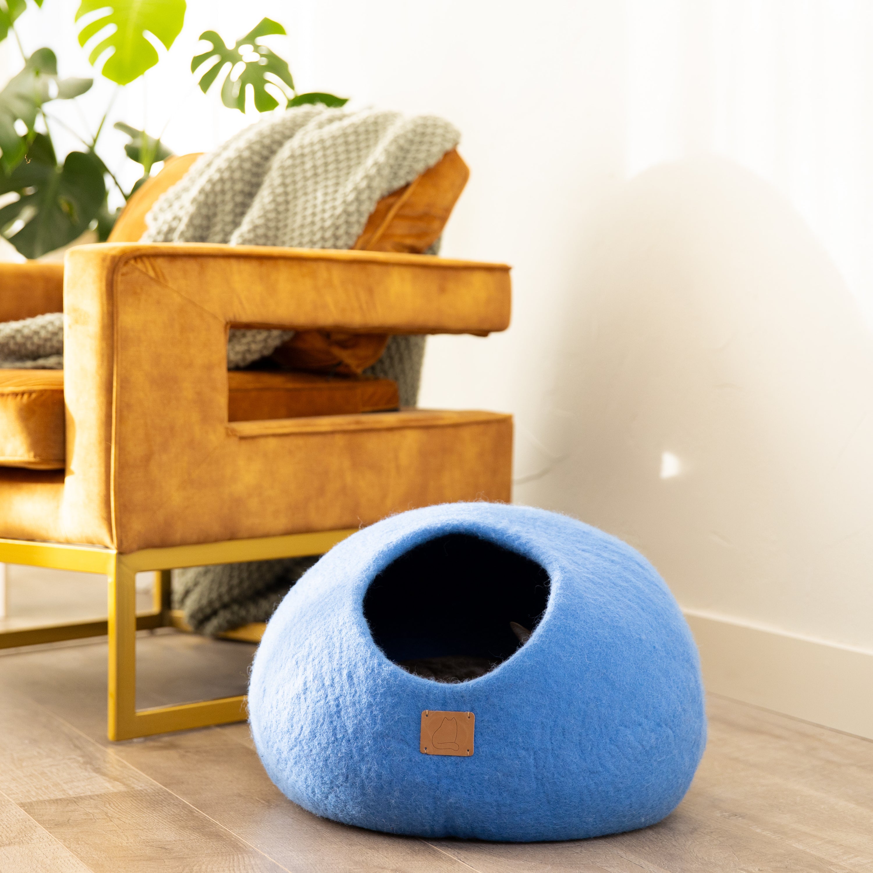 Sky Blue Round Style Cave, a cozy felted wool cat bed designed for comfort and style, featuring a peekaboo design and elegant appearance.