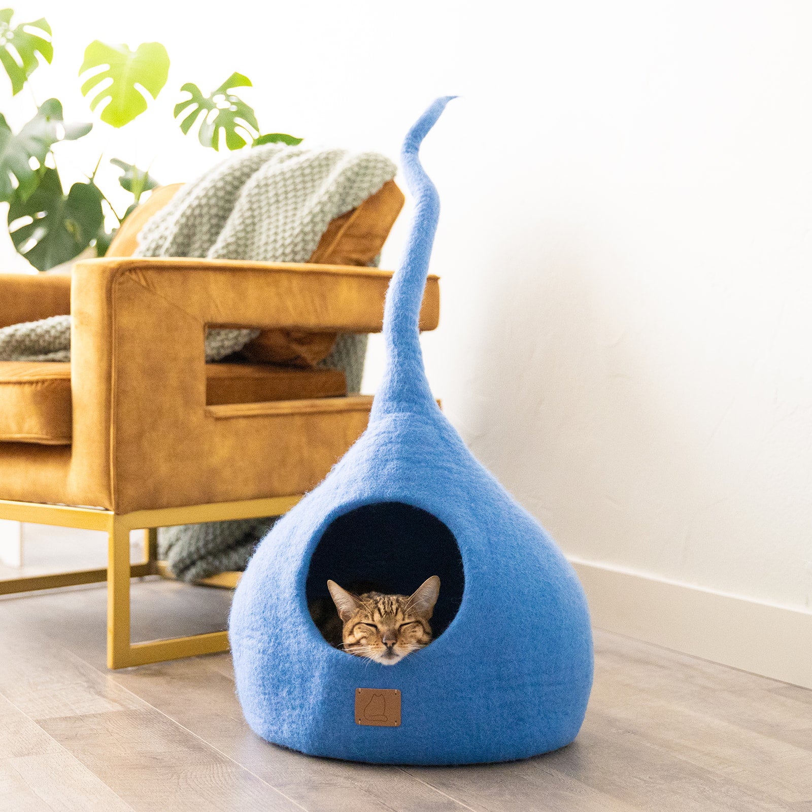 Sky Blue Tail Style Cave, a cozy and stylish cat bed made from felted wool, featuring a peekaboo entrance and modern design.