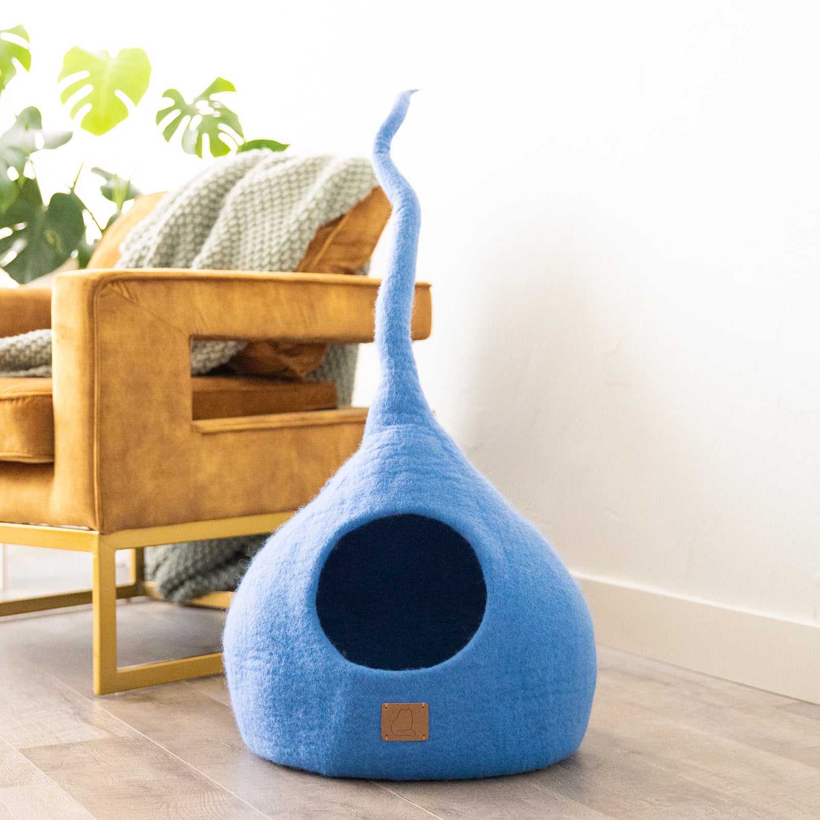 Sky Blue Tail Style Cave, a cozy and stylish cat bed made from felted wool, featuring a peekaboo entrance and modern design.