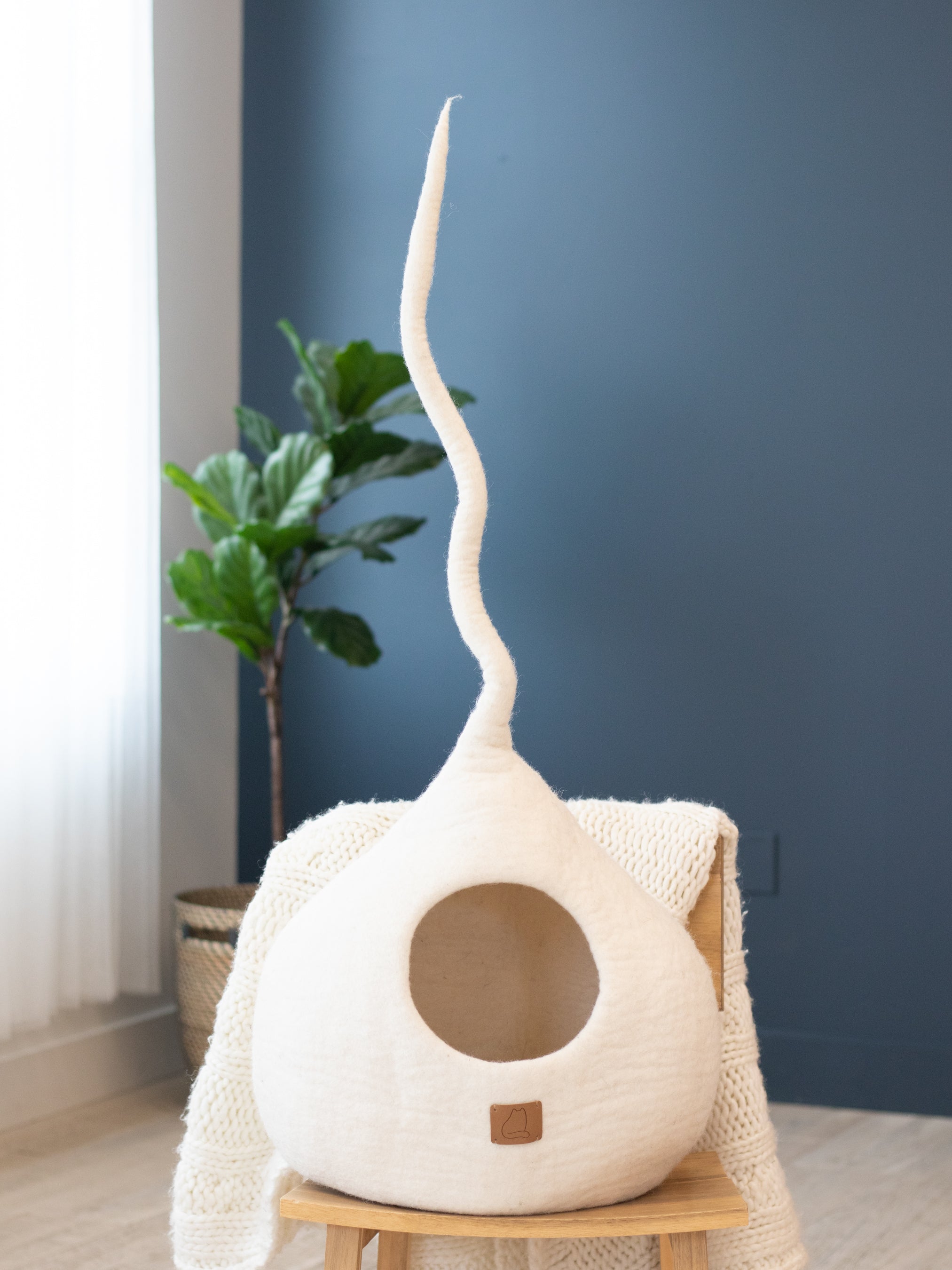 Snow White Tail Style Cave for cats, handcrafted from felted wool, featuring a peekaboo entrance and modern design, perfect for home decor.