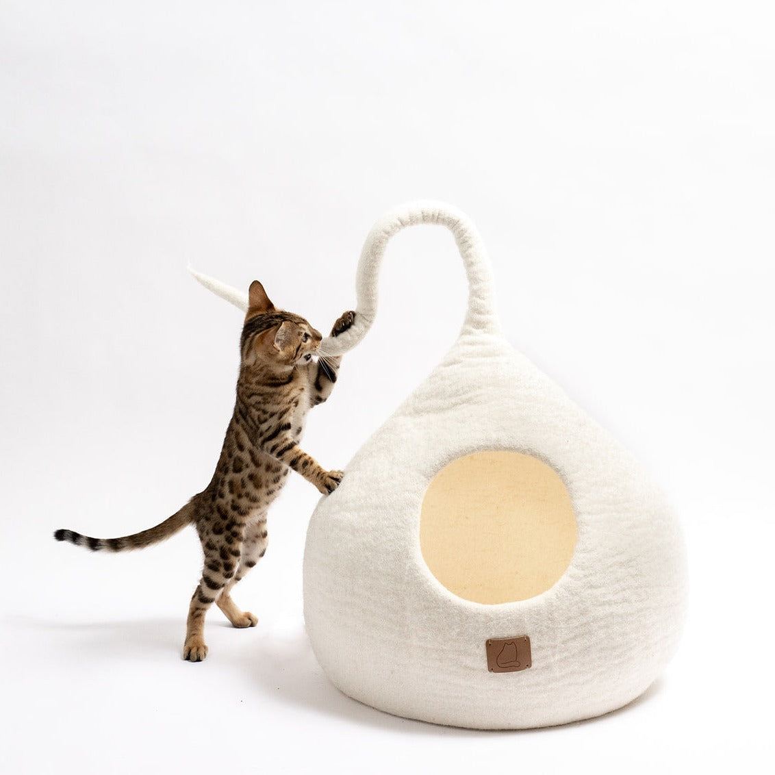 Snow White Tail Style Cave for cats, handcrafted from felted wool, featuring a peekaboo entrance and modern design, perfect for home decor.