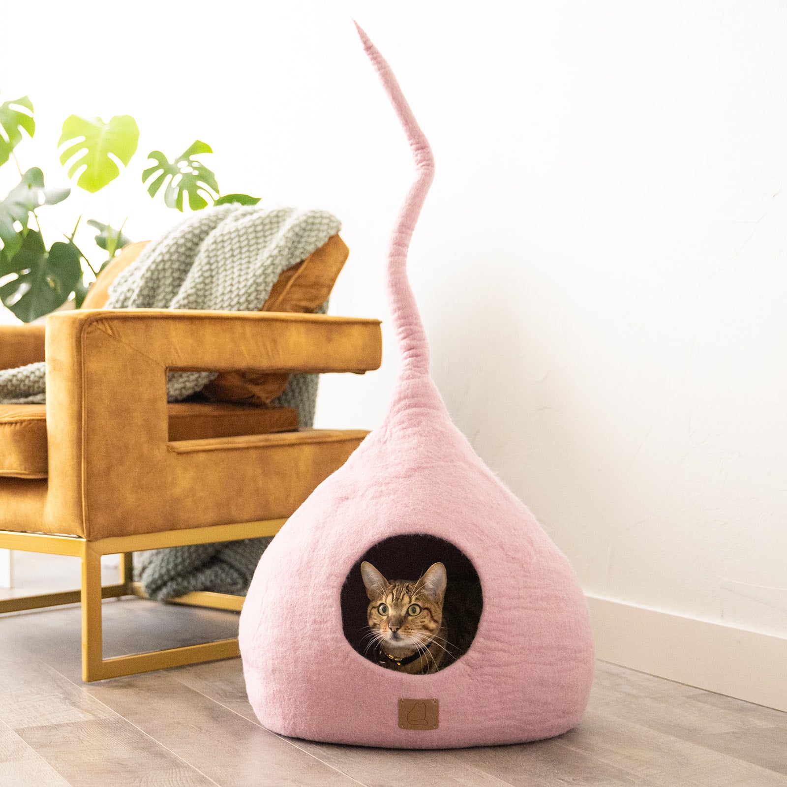 Valentine Pink Tail Style Cave, a cozy and stylish cat bed made from felted wool, featuring a peekaboo entrance and a modern design.