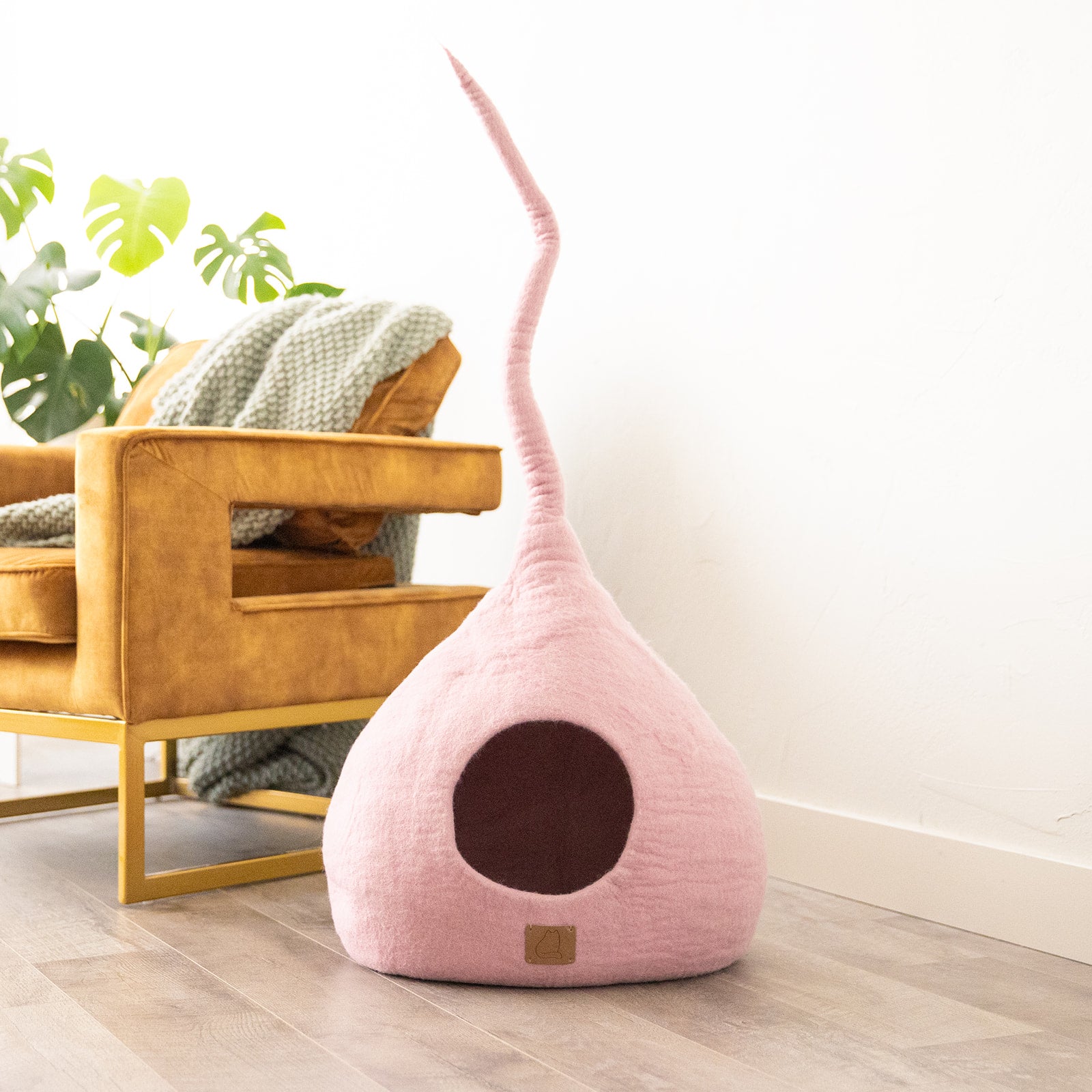 Valentine Pink Tail Style Cave, a cozy and stylish cat bed made from felted wool, featuring a peekaboo entrance and a modern design.