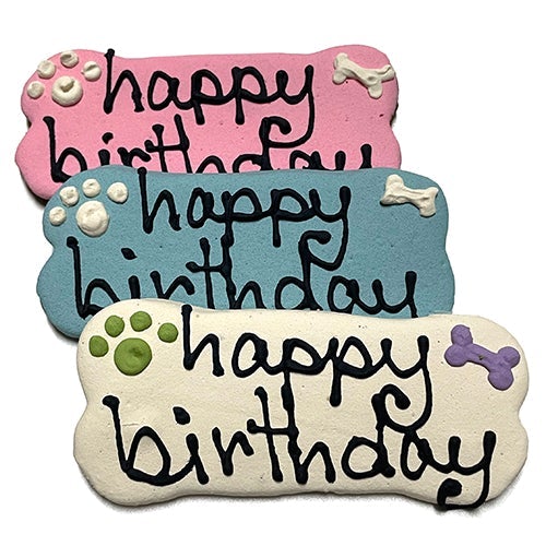 A pack of Birthday Bones dog treats, shaped like bones and topped with yogurt coating, featuring a peanut butter flavor, perfect for celebrating pet birthdays.