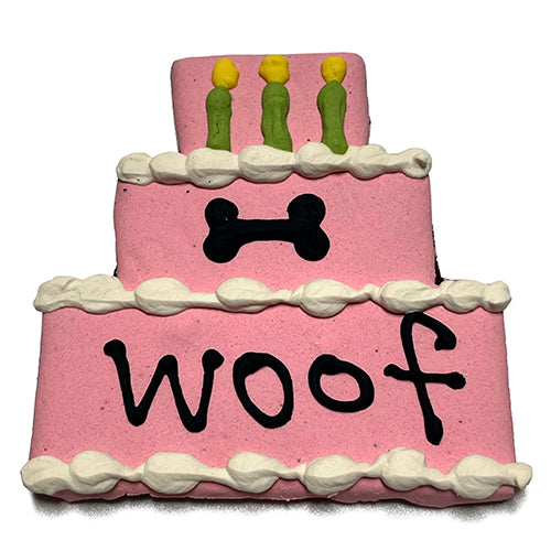 A colorful assortment of Cake Treats for dogs, featuring a large birthday cake design, topped with yogurt coating and vibrant vegetable coloring.