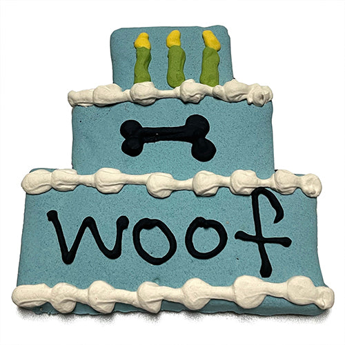 A colorful assortment of Cake Treats for dogs, featuring a large birthday cake design, topped with yogurt coating and vibrant vegetable coloring.