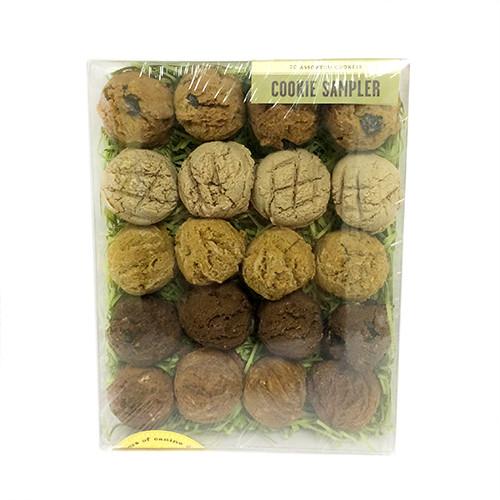 A colorful Cookie Sampler Box containing 20 assorted dog cookies, including Carob Chip, Snickerdoodles, and more, beautifully packaged.