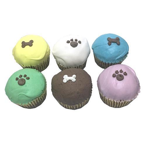 A six-pack of dog cupcakes featuring soft peanut butter banana flavor, topped with a hard yogurt coating, perfect for medium to large dogs.